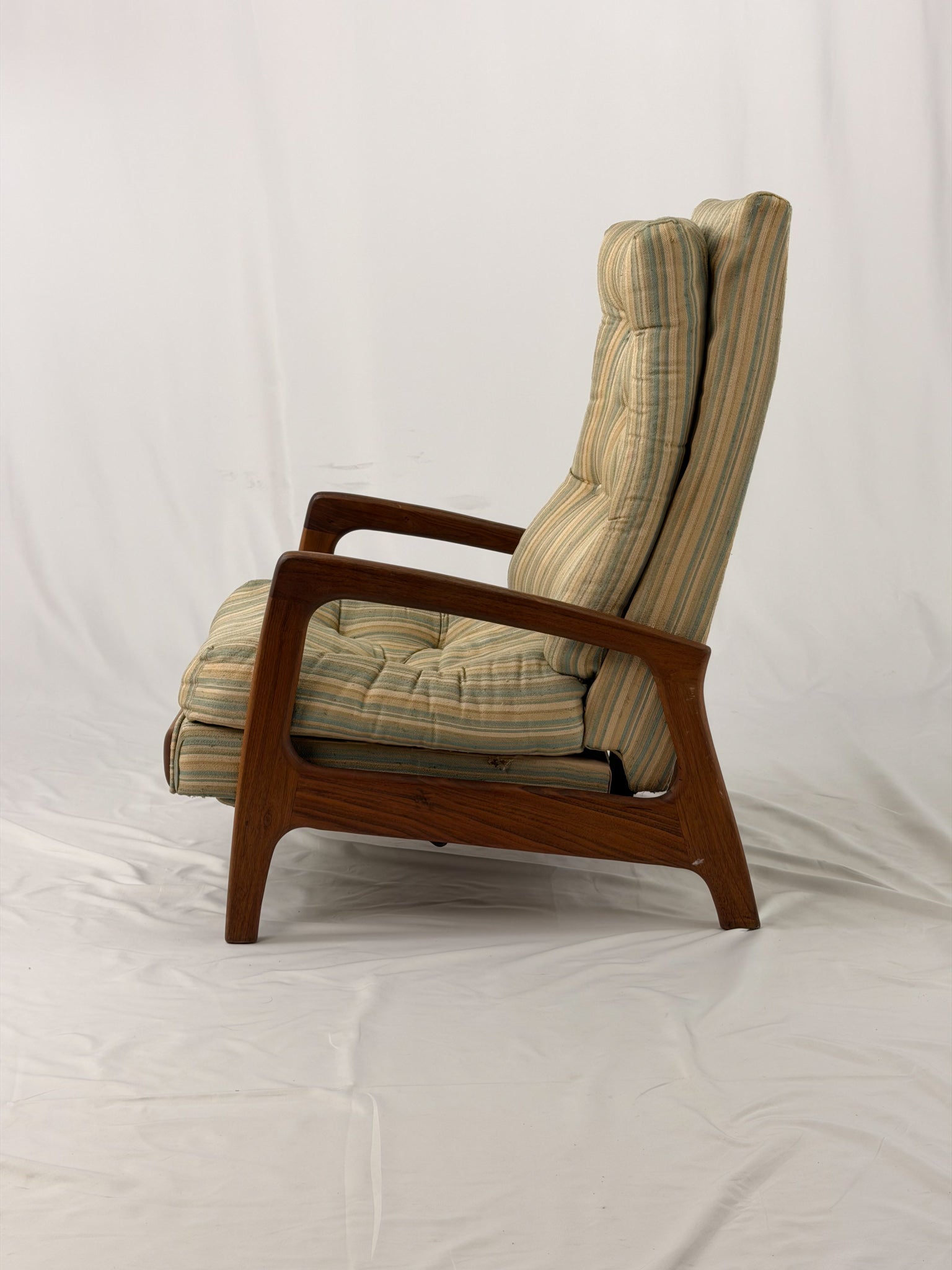 Vintage Adrian Pearsall recliner with striped cushion on a white background
