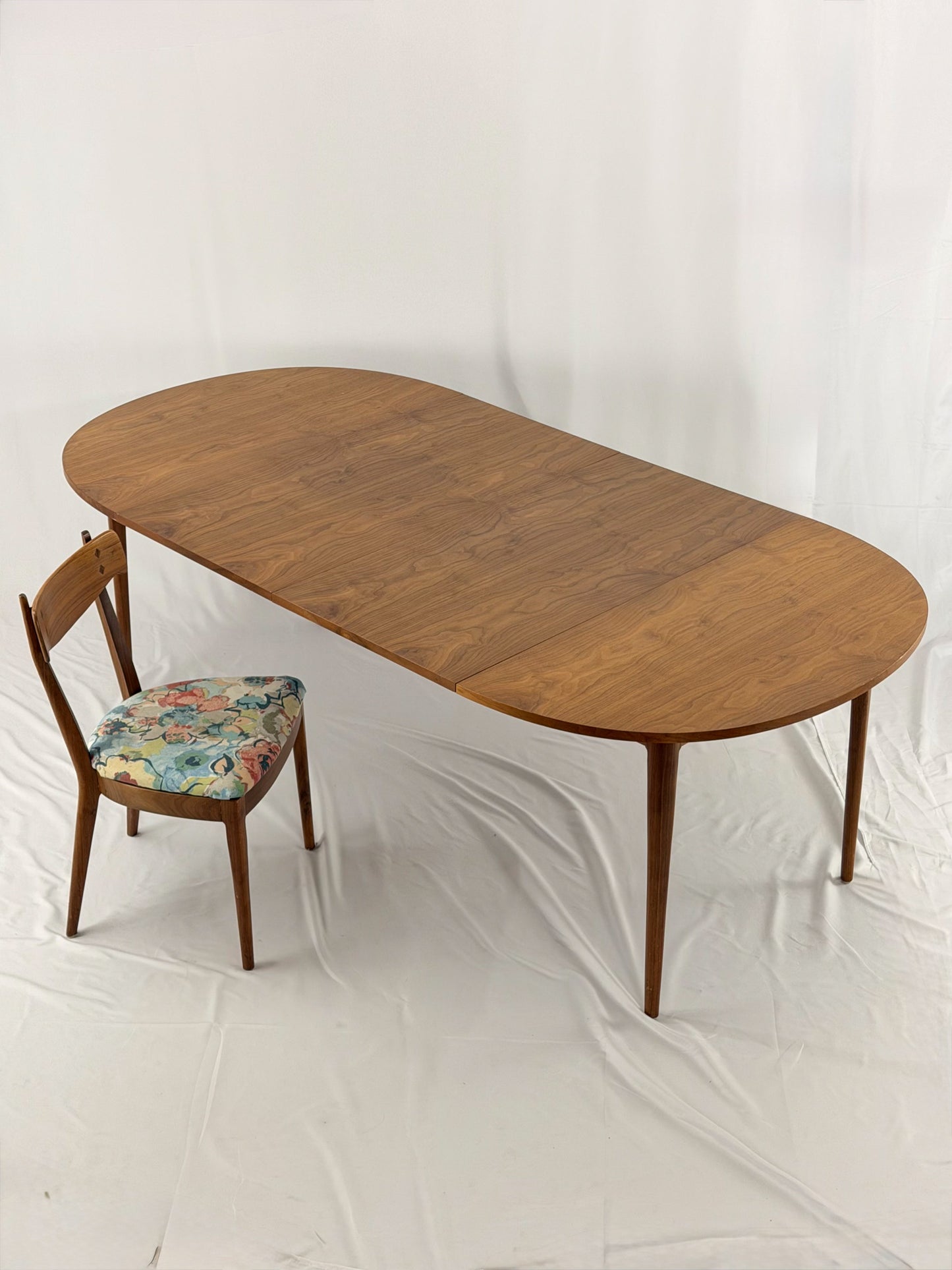 Wooden dining table with a chair on a white background