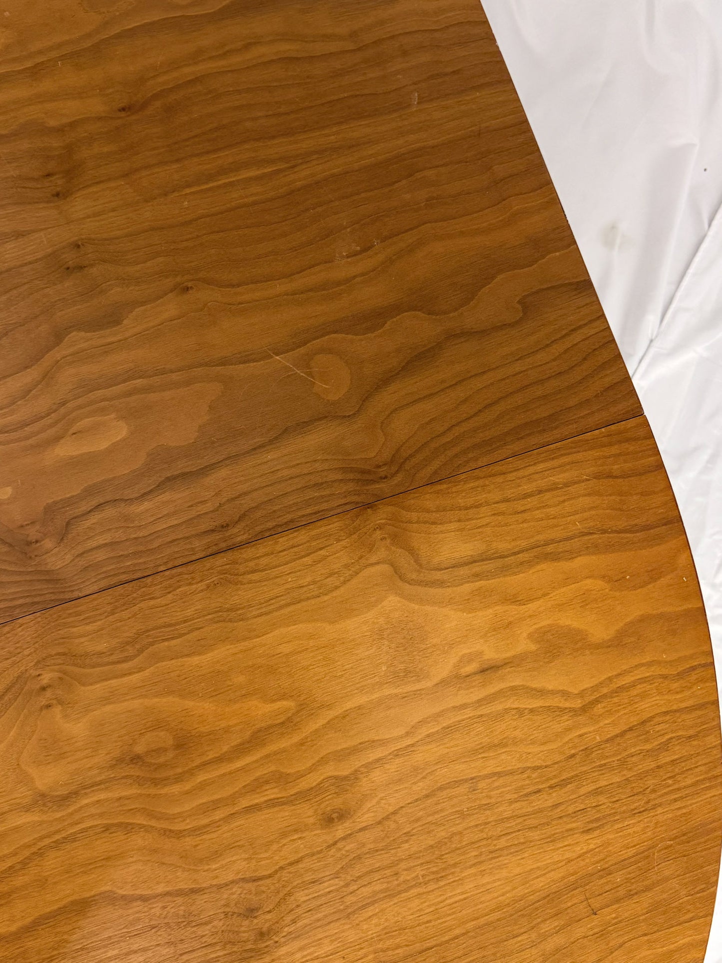 Close-up of a wooden surface with a white fabric corner.