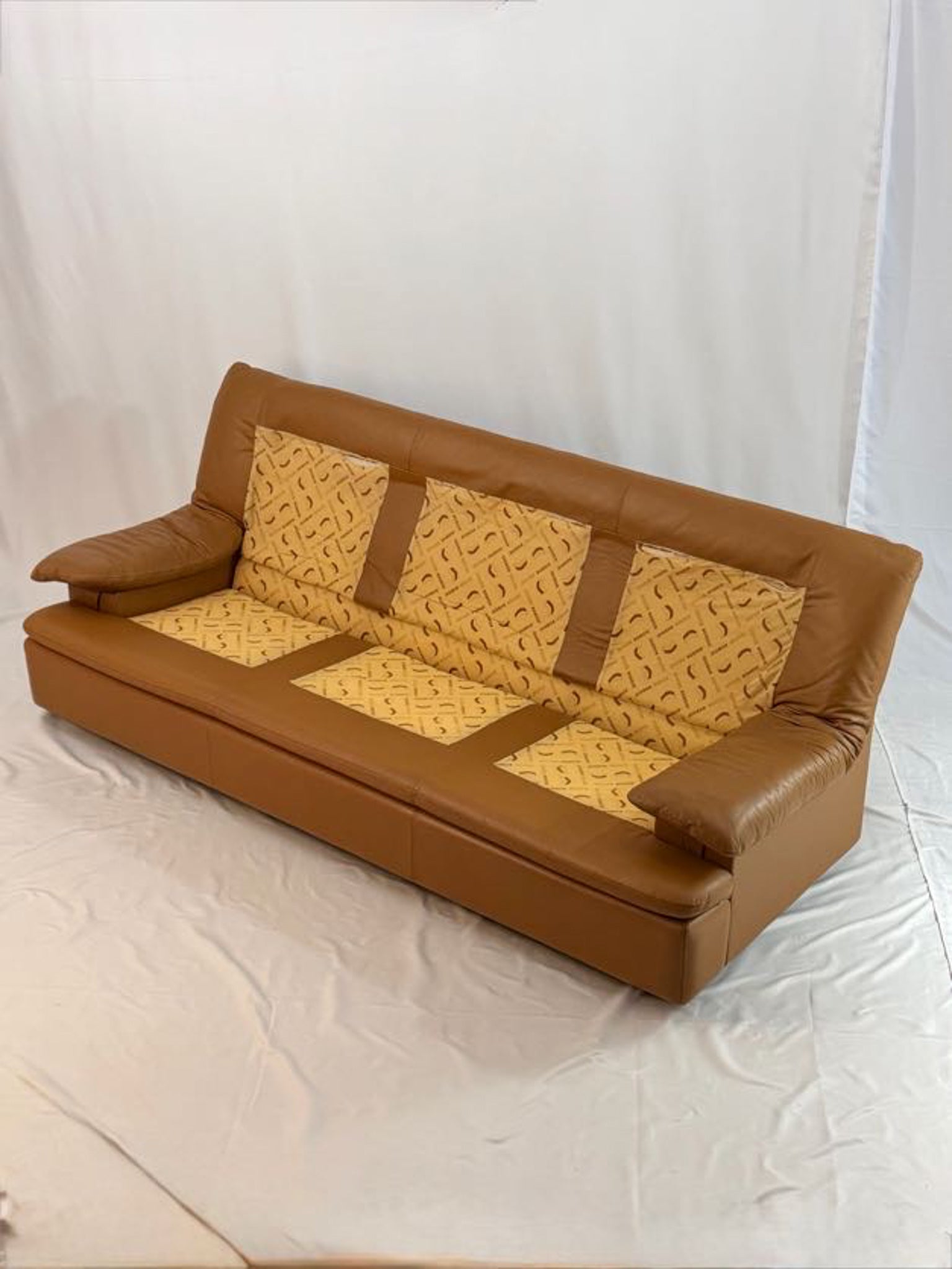 Brown leather sofa with no cusions on a white background