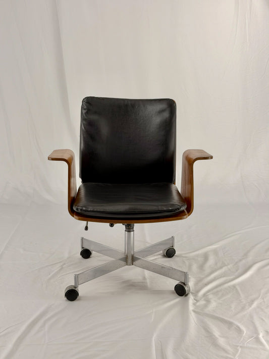 Mid Century Modern office chair with wooden frame and leather seat with a white background