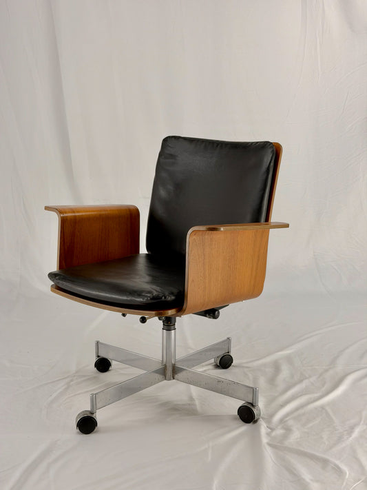 Mid Century Modern office chair with wooden frame and leather seat with a white background