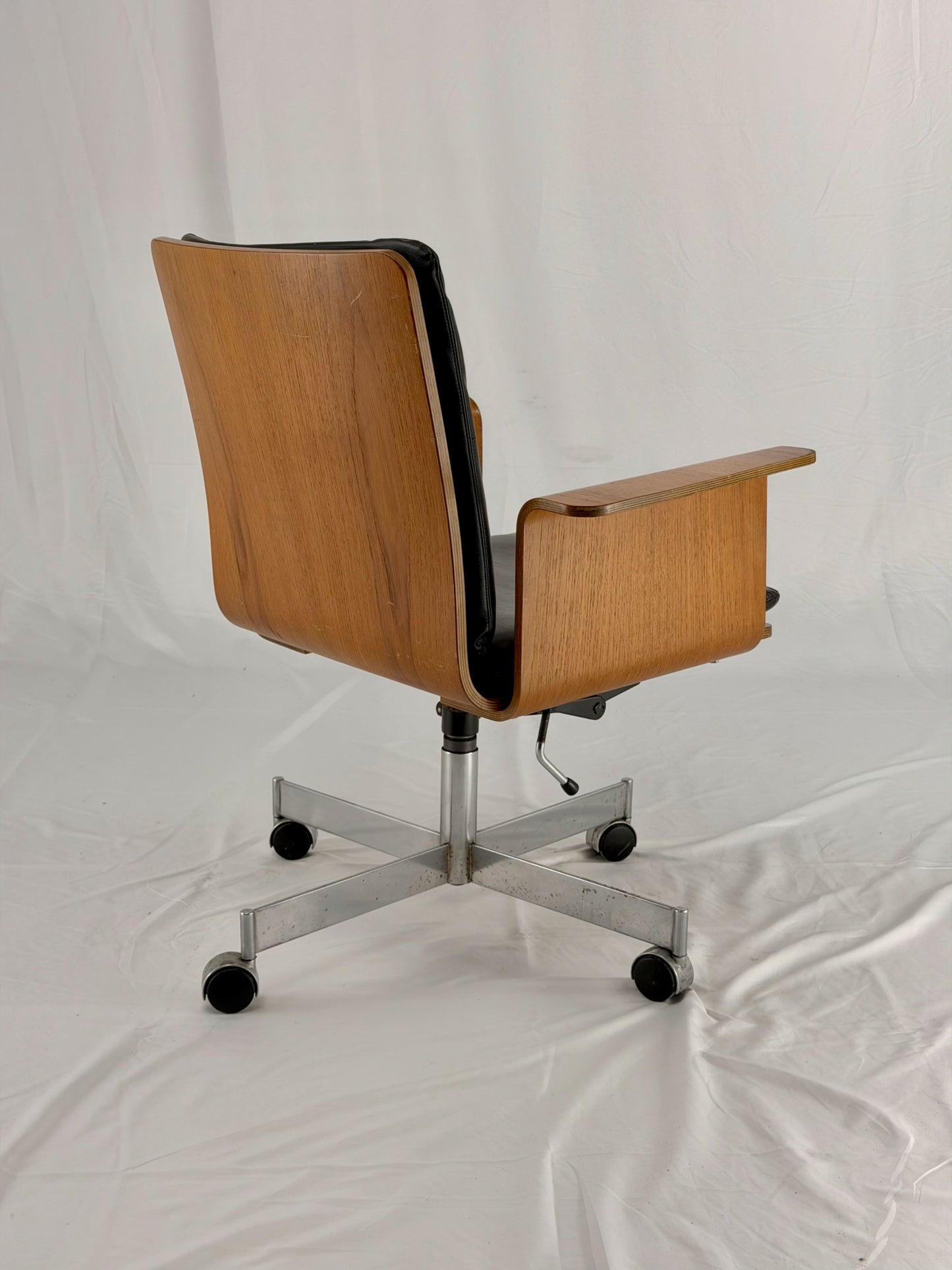 Wooden office chair with wheels on a white background