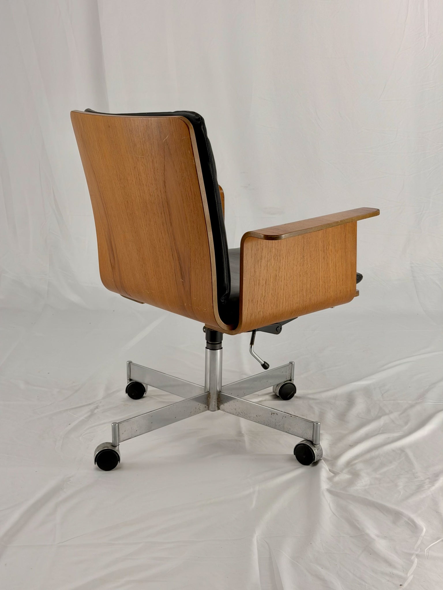 Wooden office chair with wheels on a white background