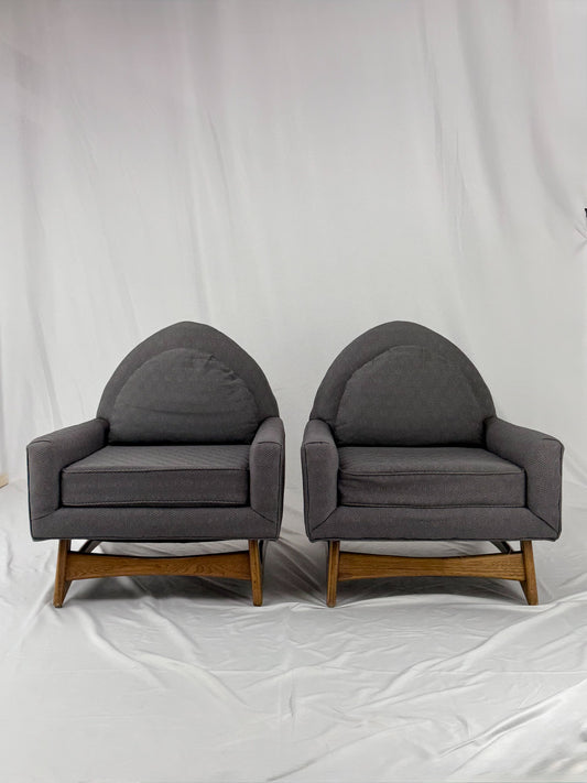Two gray armchairs with wooden legs on a white background