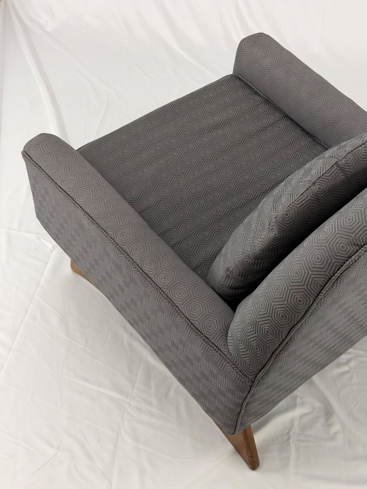 Gray armchair with wooden legs on a white background