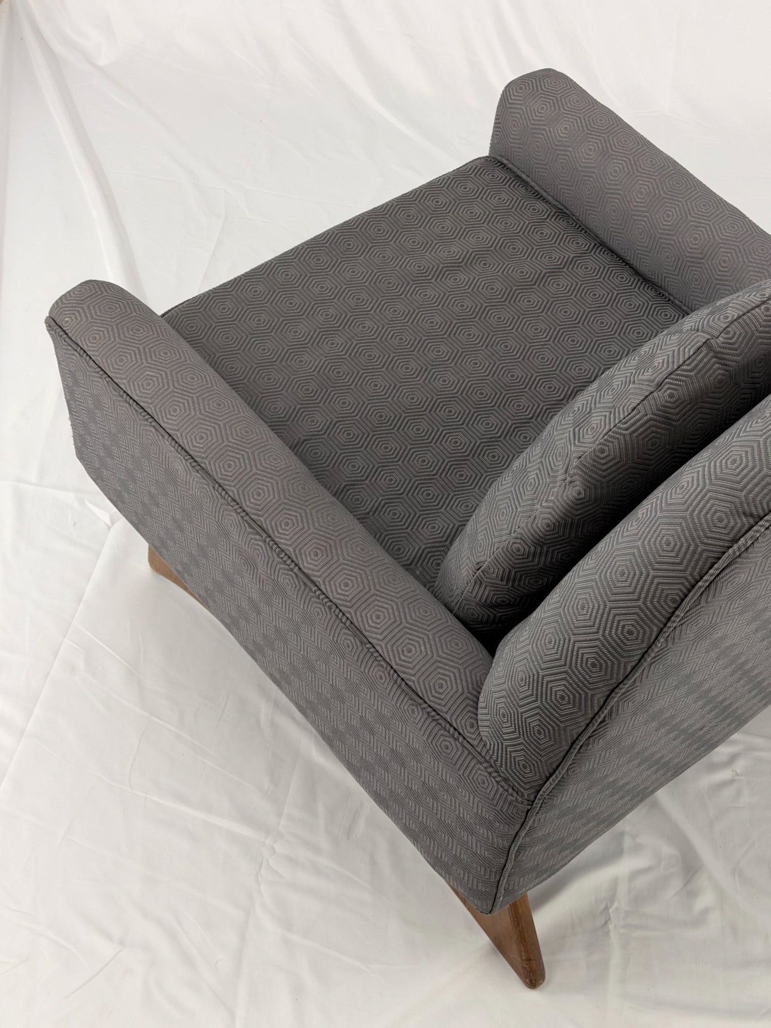 Gray armchair with wooden legs on a white background