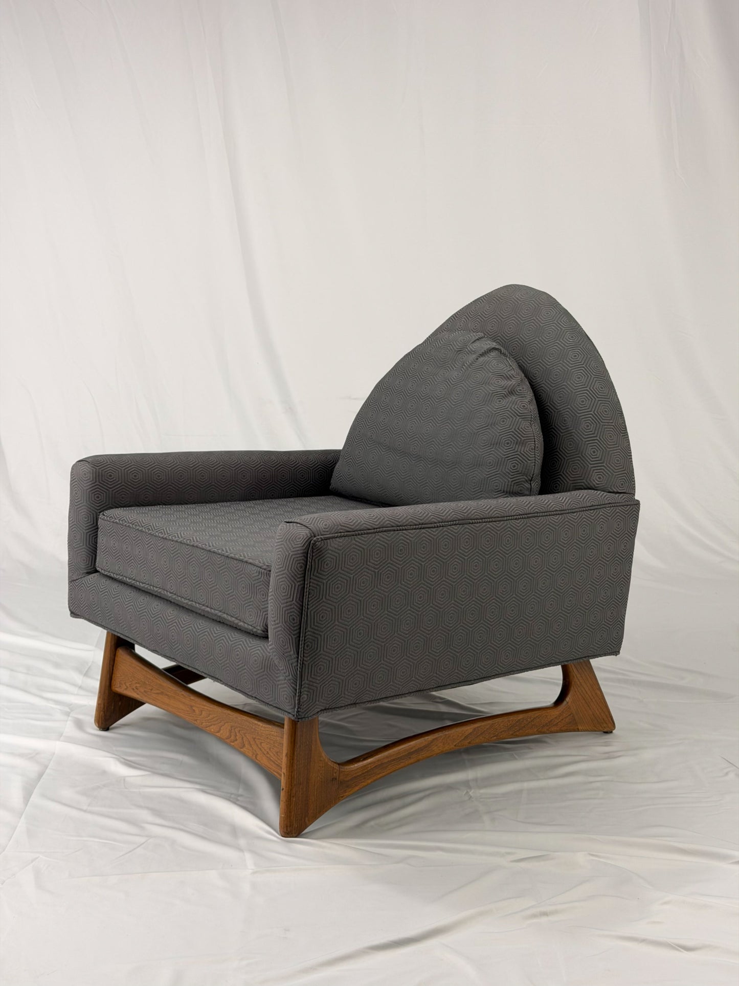 Gray armchair with wooden legs on a white background