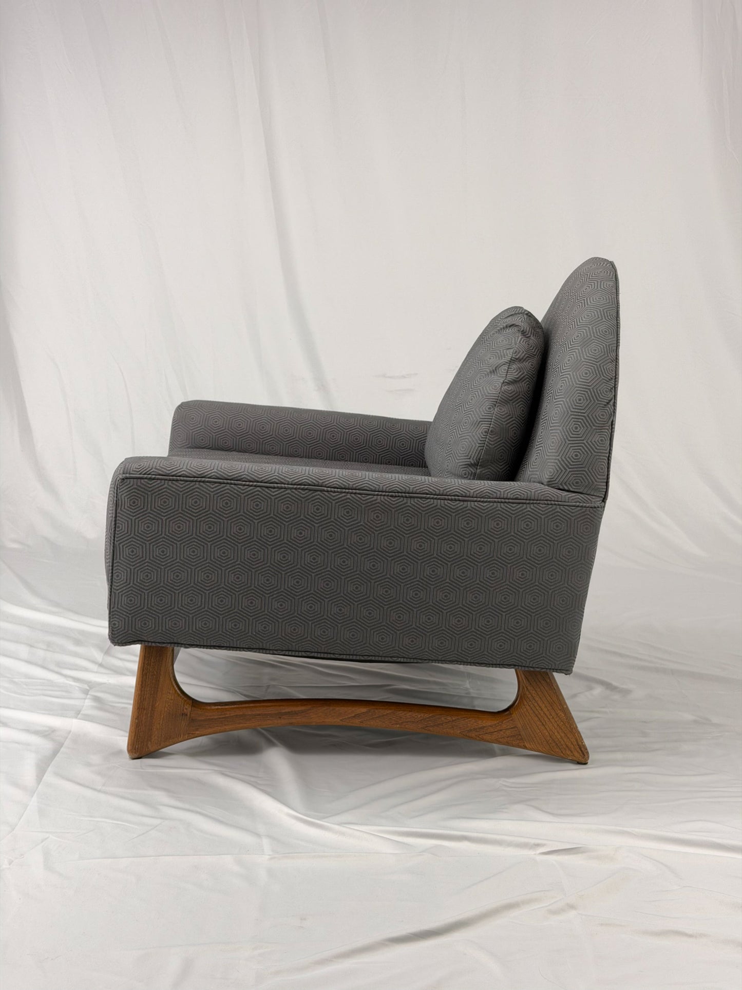Gray armchair with wooden legs on a white background