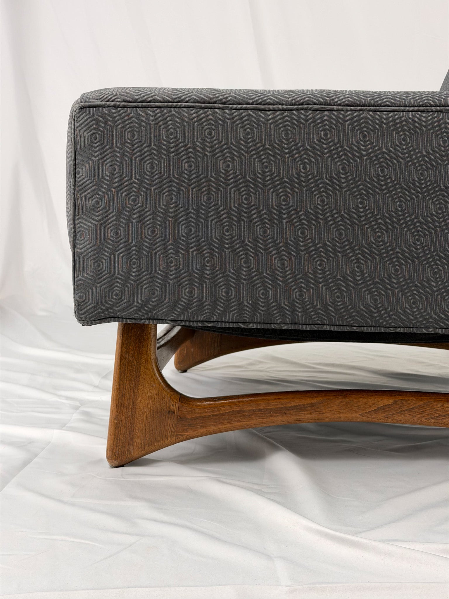 Gray armchair with wooden legs on a white background