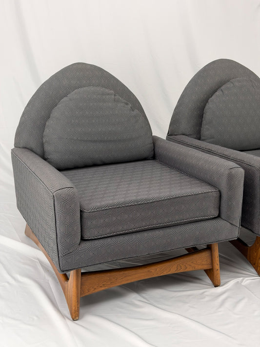 Two gray armchairs with wooden legs on a white background