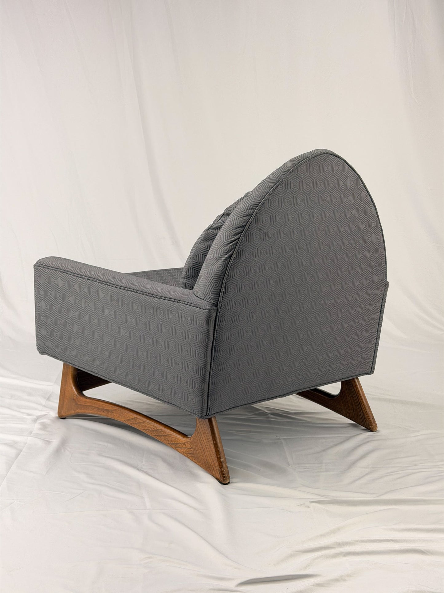 Gray armchair with wooden legs on a white background