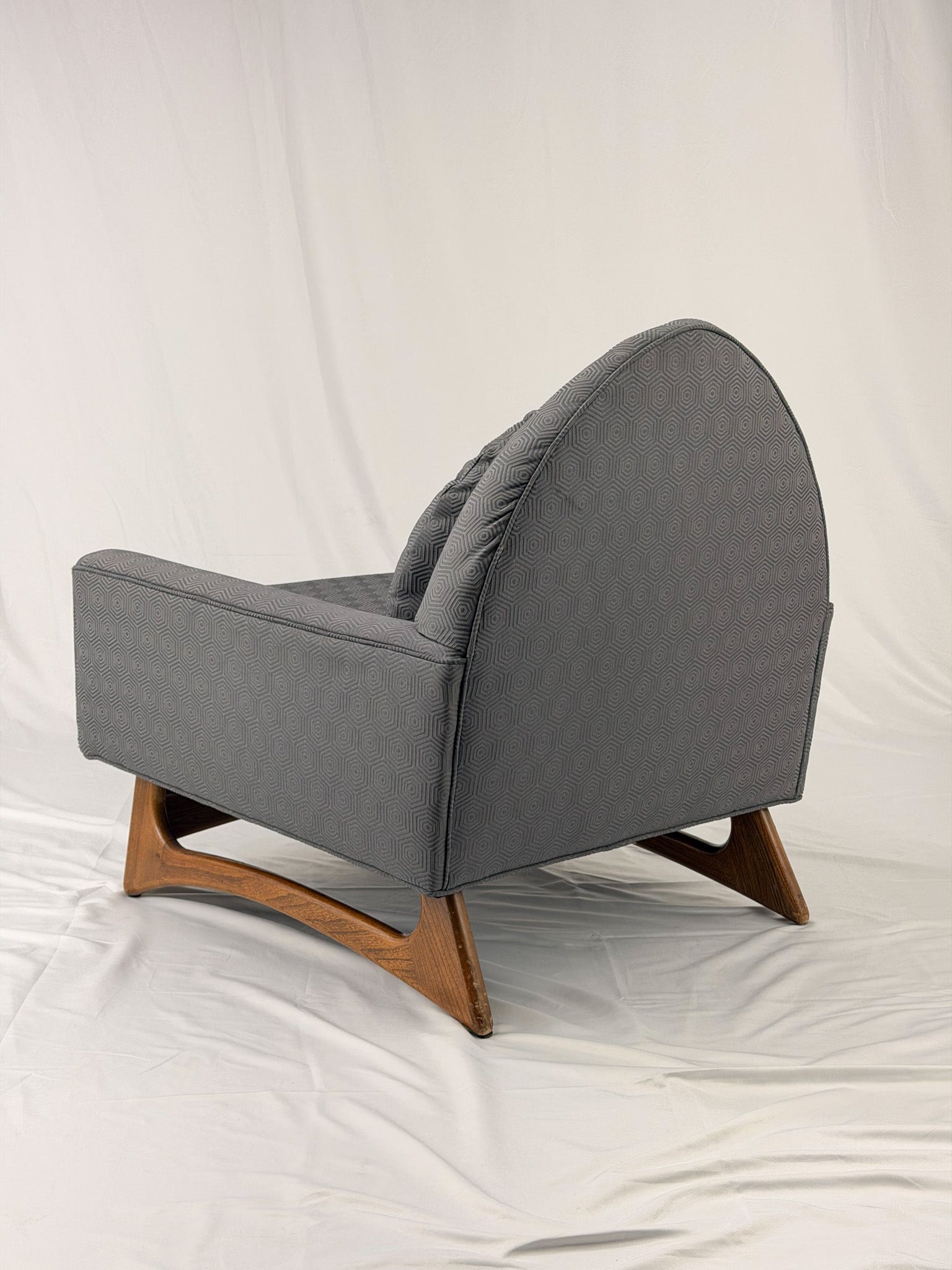 Gray armchair with wooden legs on a white background