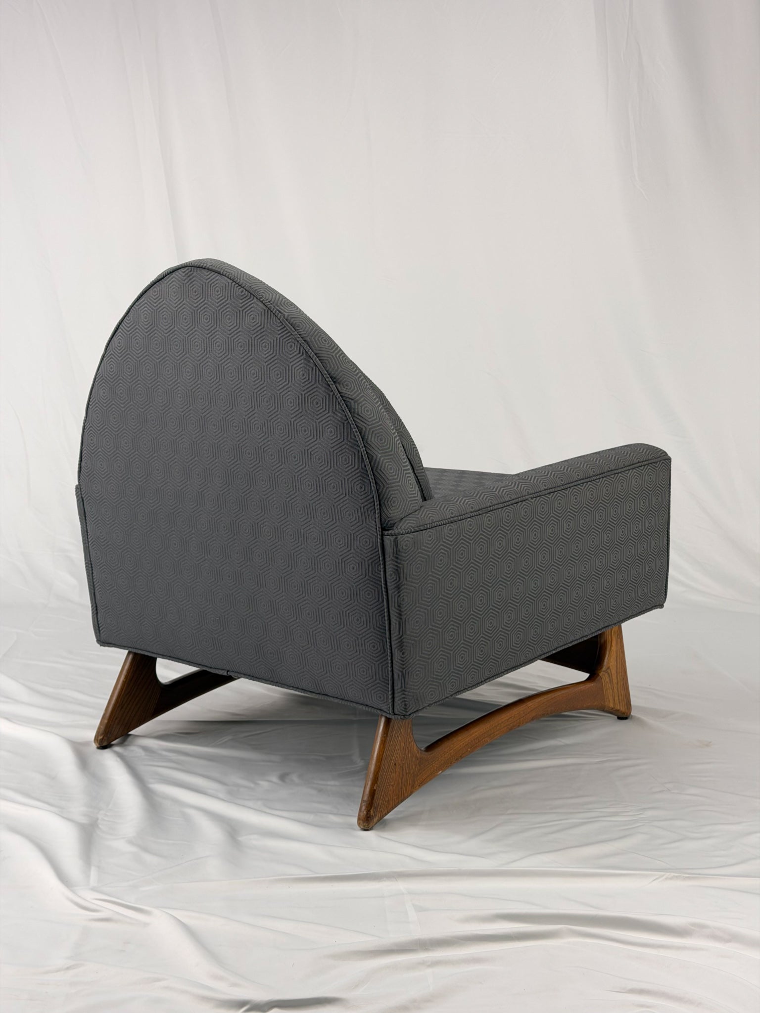 Gray armchair with wooden legs on a white background