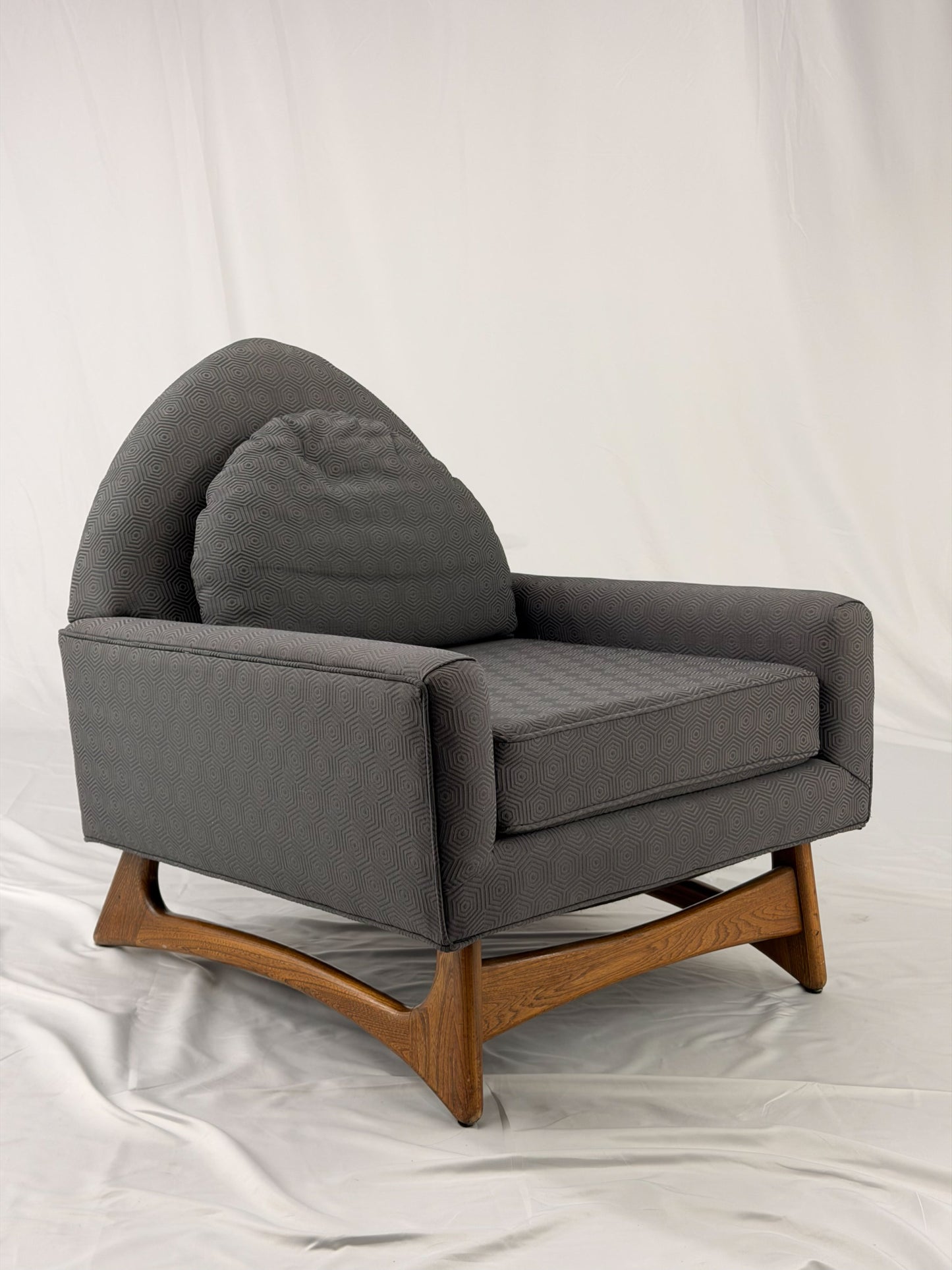 Gray armchair with wooden legs on a white background