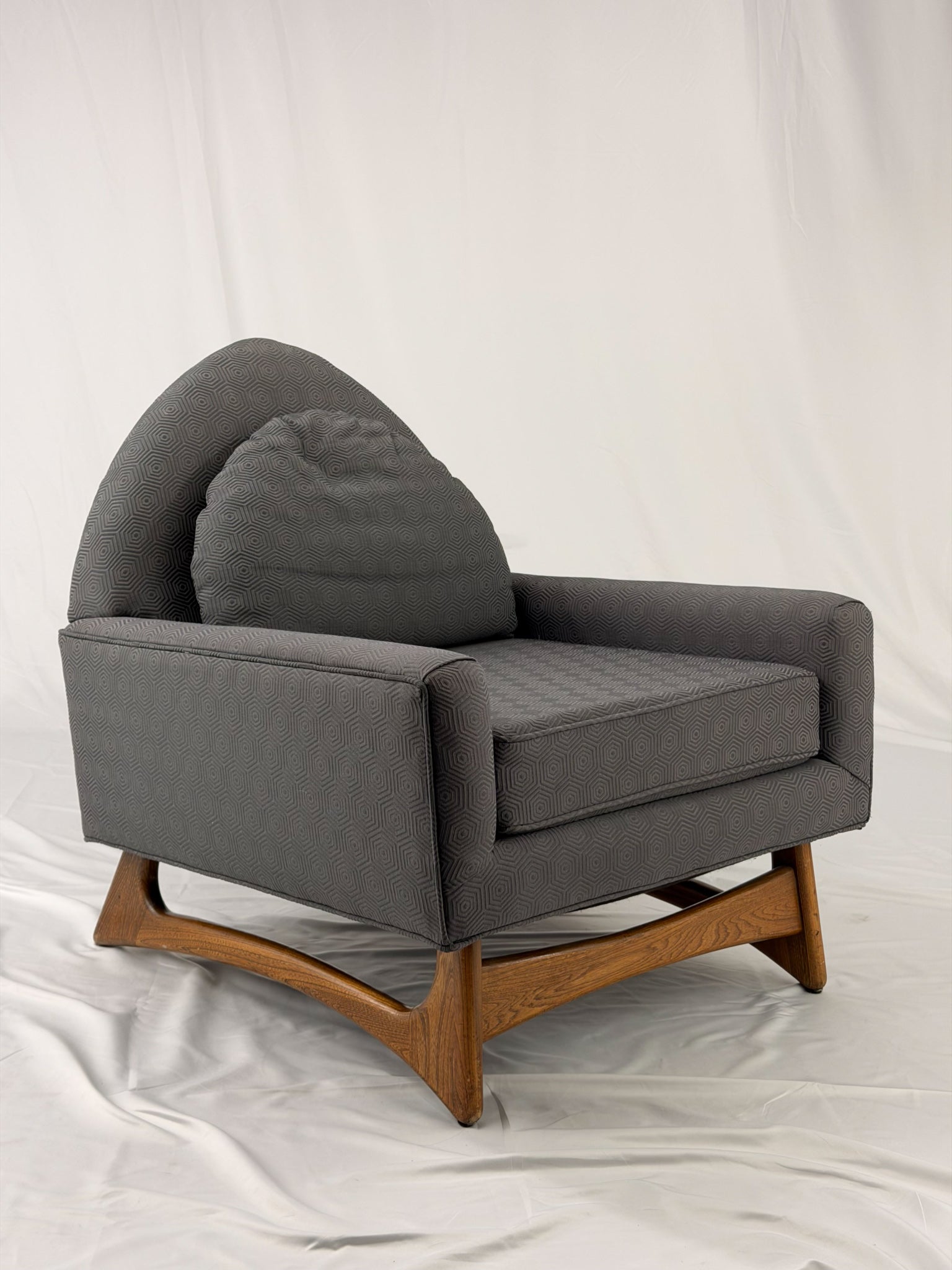 Gray armchair with wooden legs on a white background