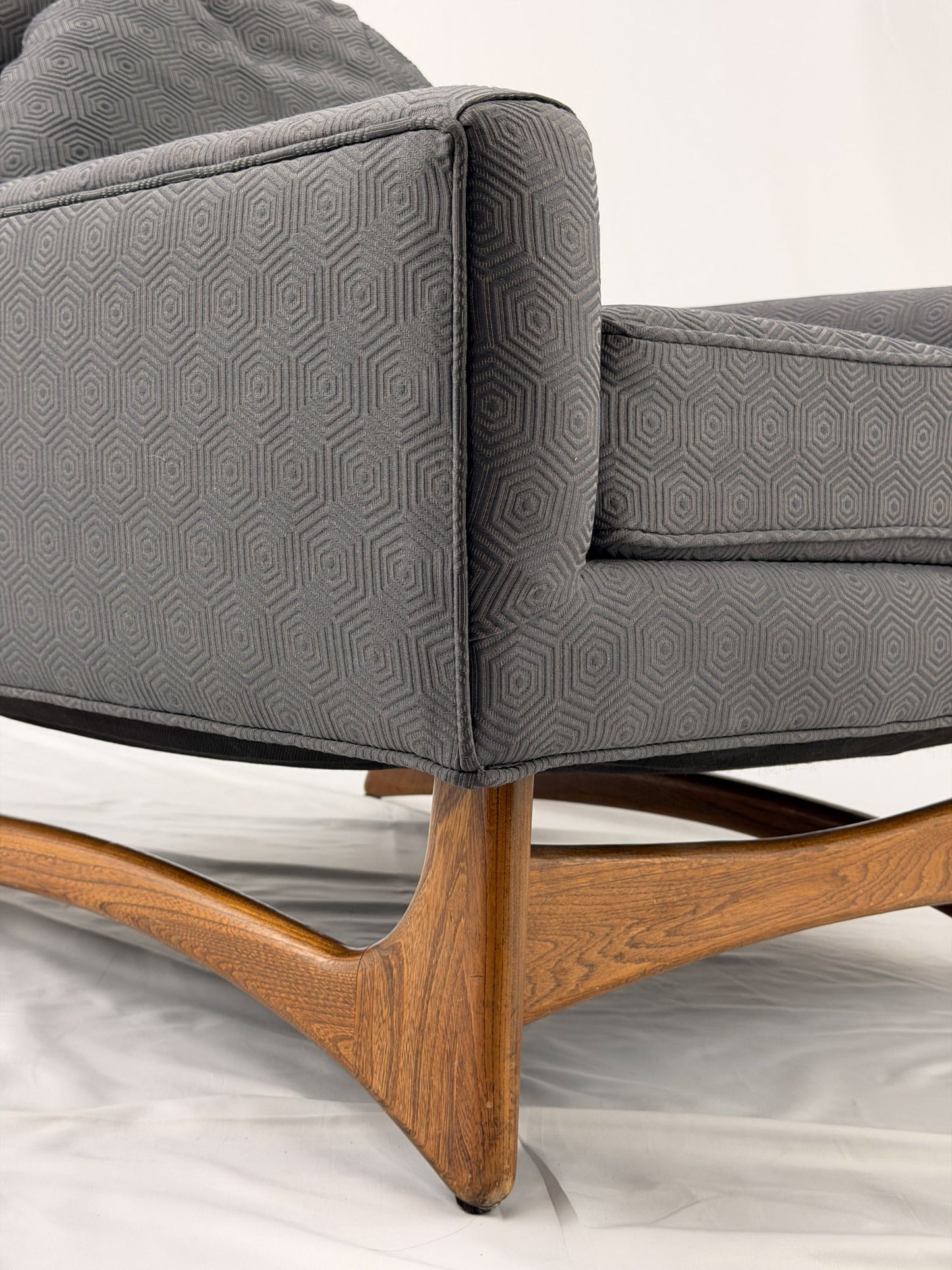 Gray armchair with wooden legs on a white background