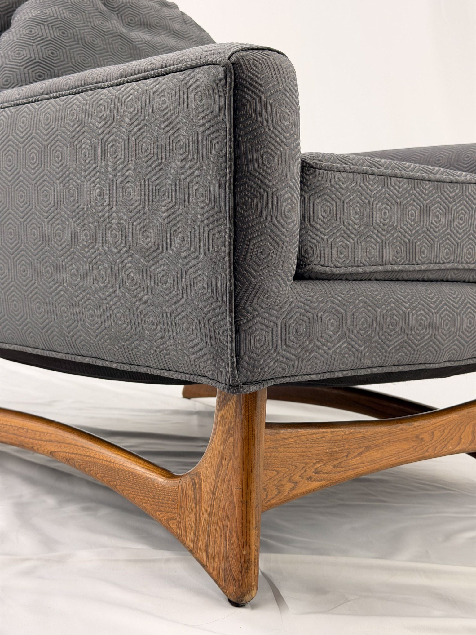 Gray armchair with wooden legs on a white background