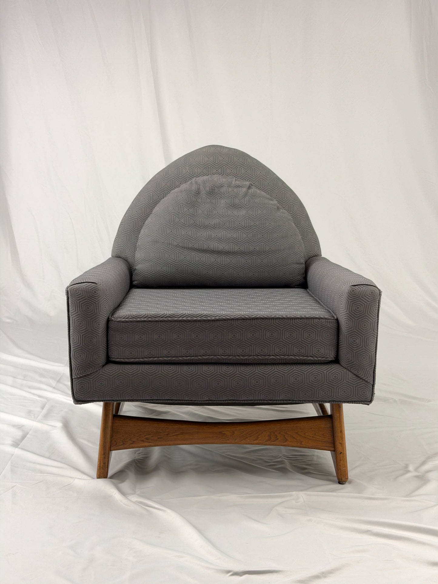 Gray armchair with wooden legs on a white background