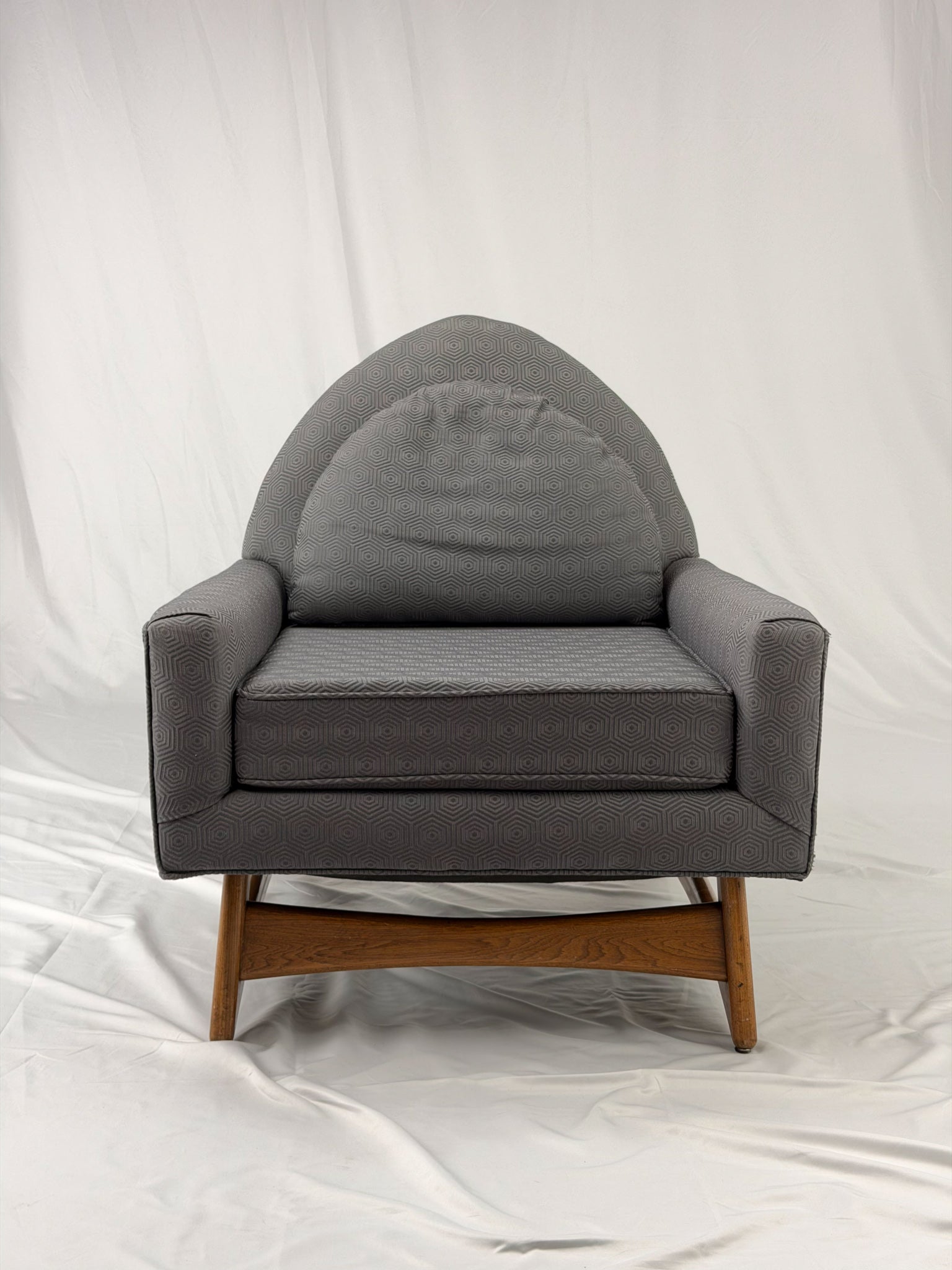 Gray armchair with wooden legs on a white background