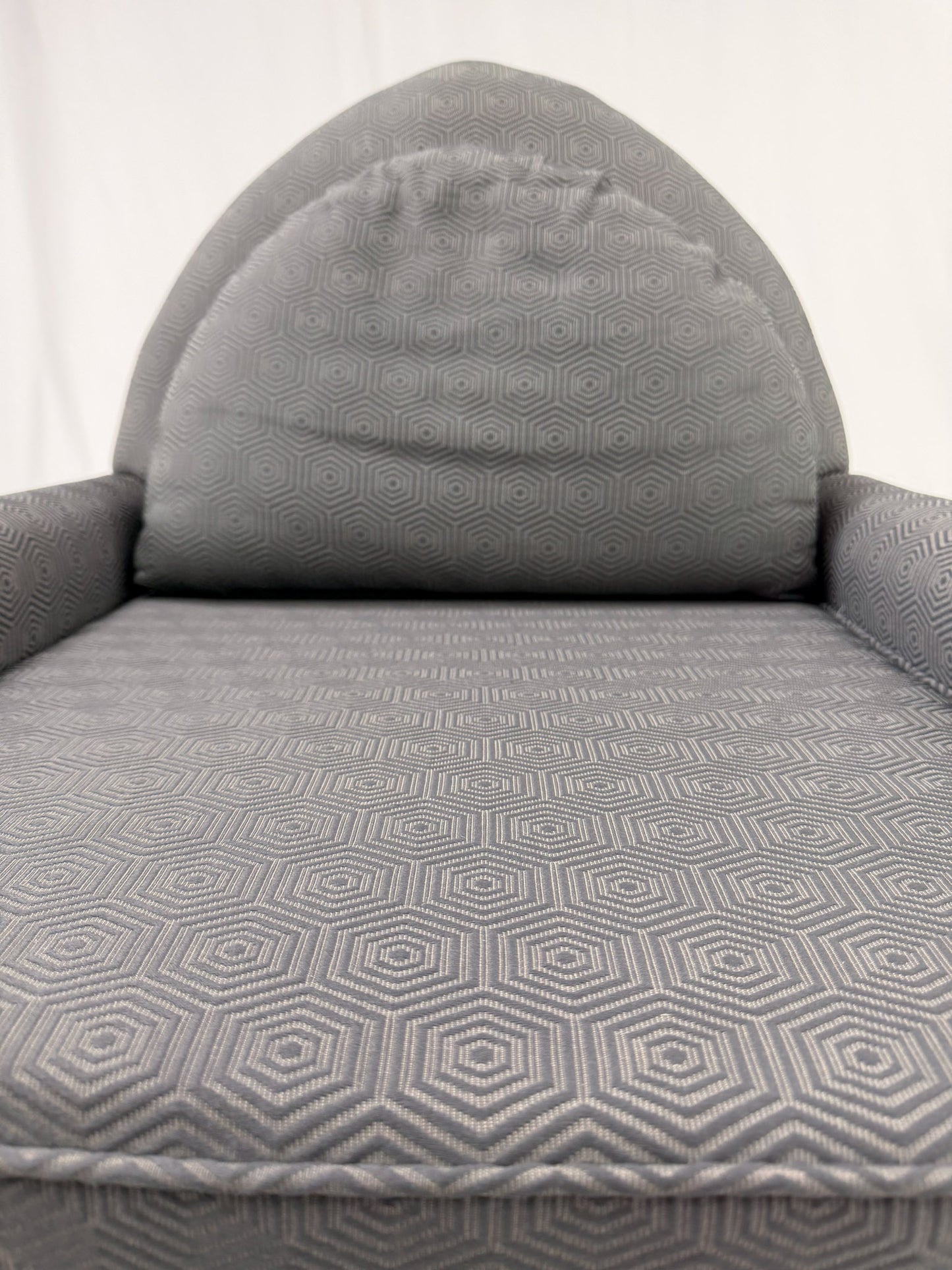 Gray armchair with wooden legs on a white background