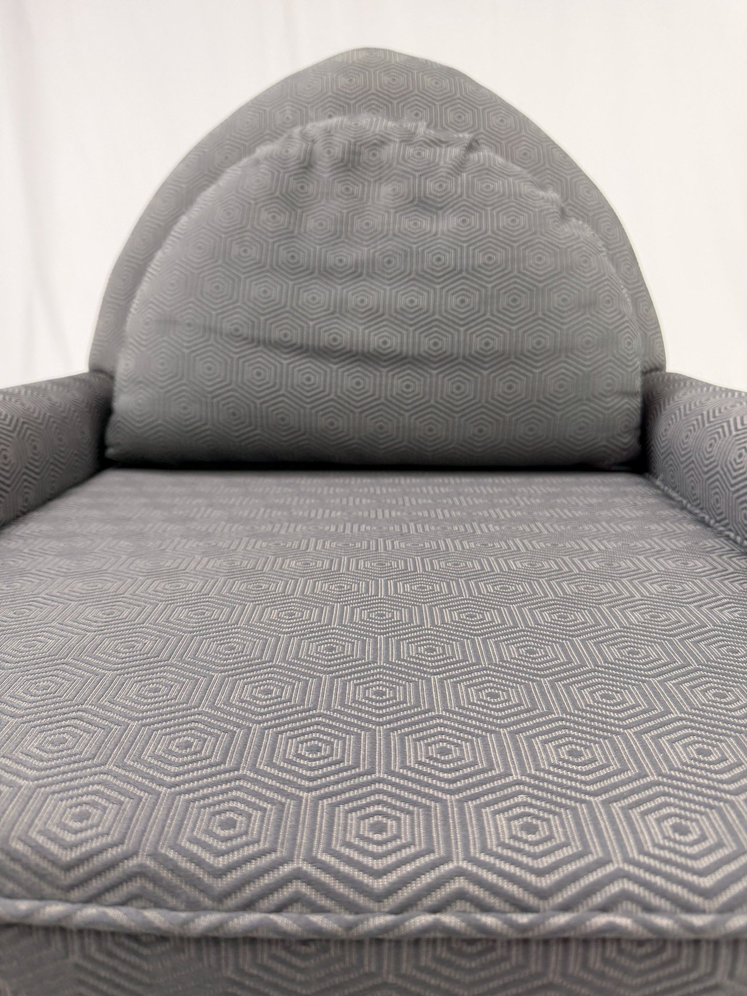 Gray armchair with wooden legs on a white background