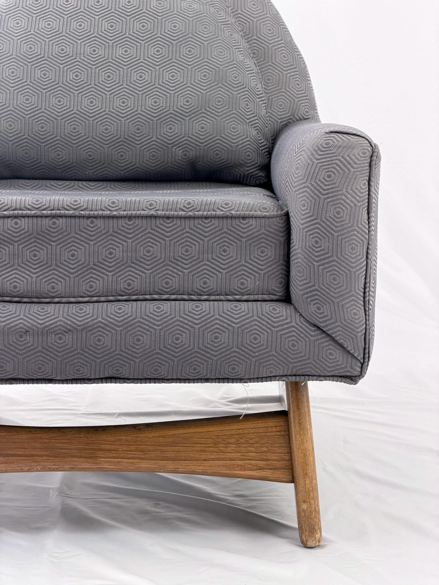 Gray armchair with wooden legs on a white background