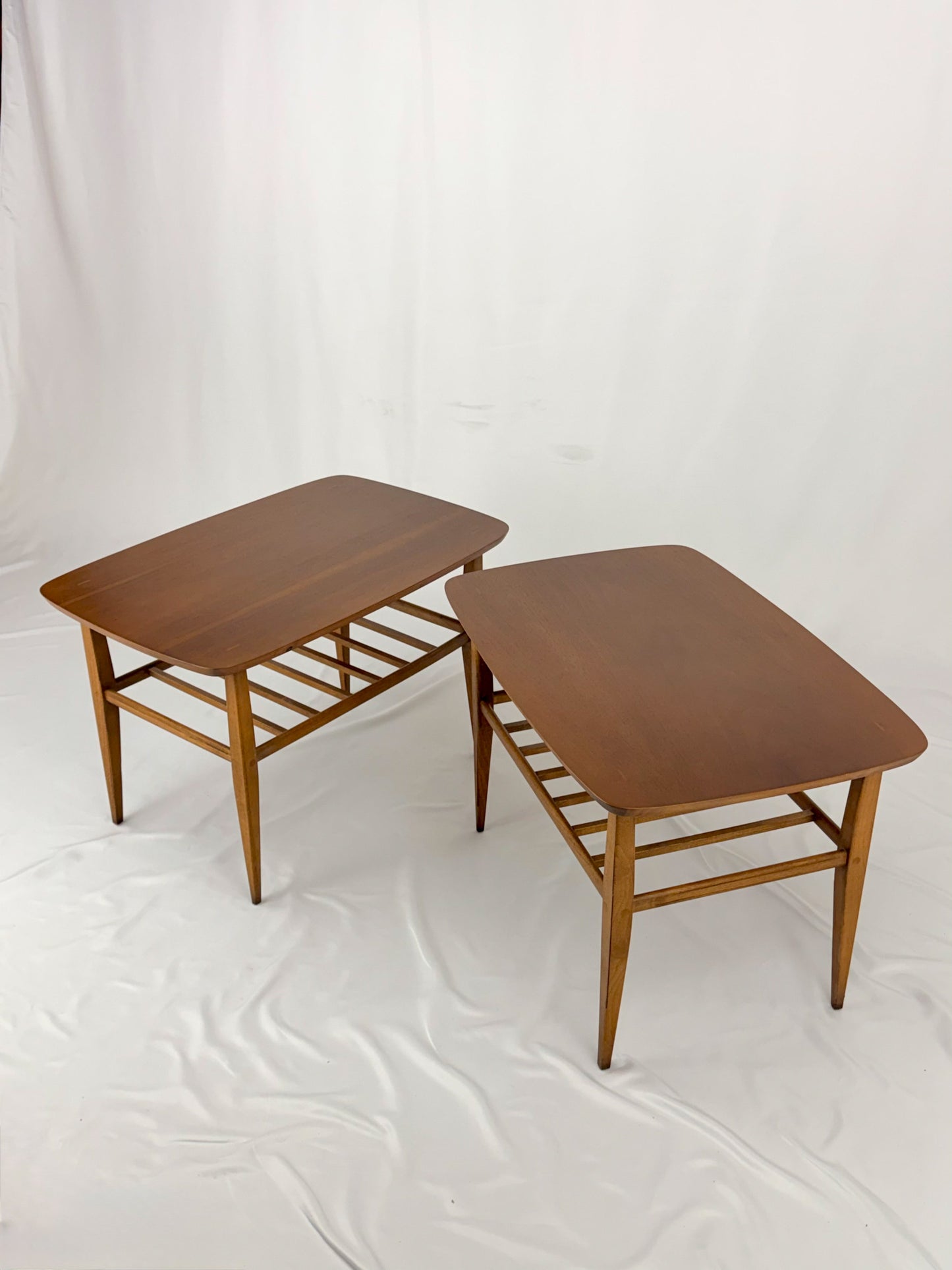 Two wooden side tables on a white background