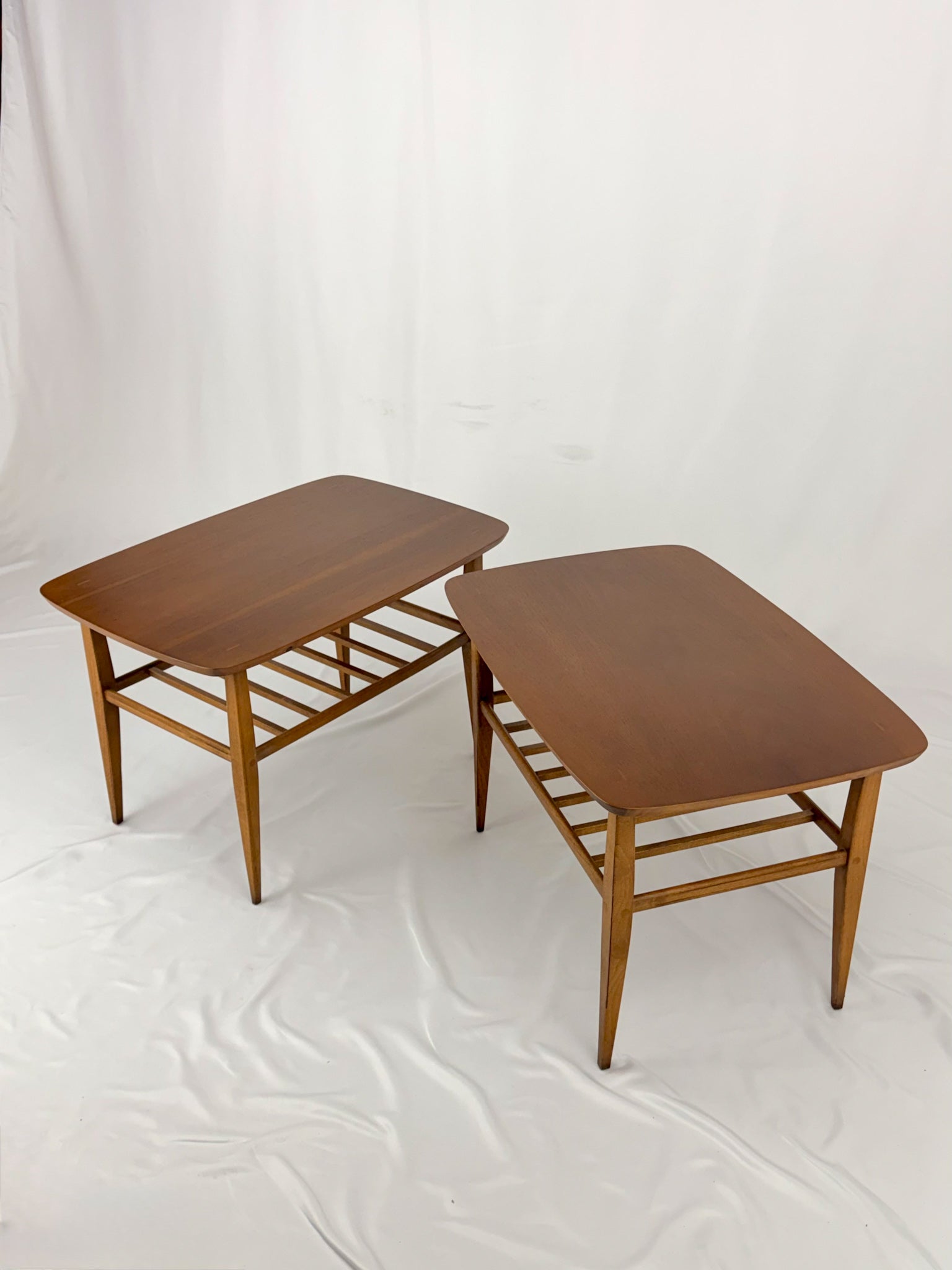 Two wooden side tables on a white background