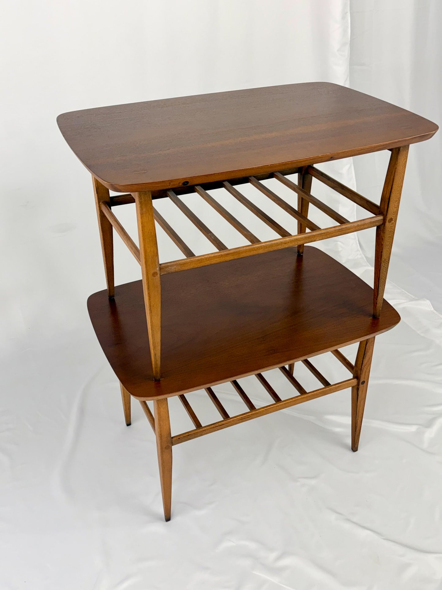 Two wooden side tables on a white background