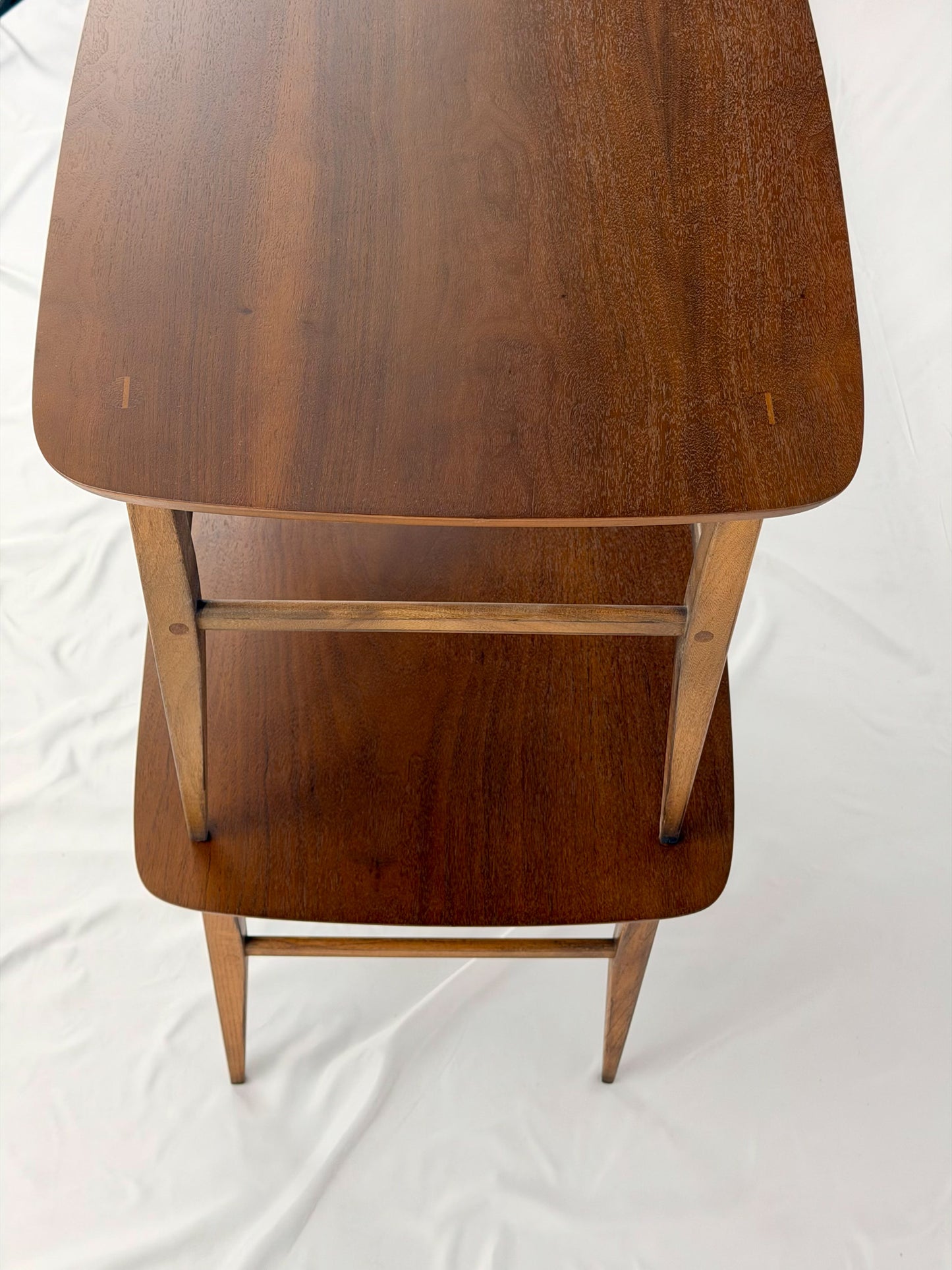 Two wooden side tables on a white background