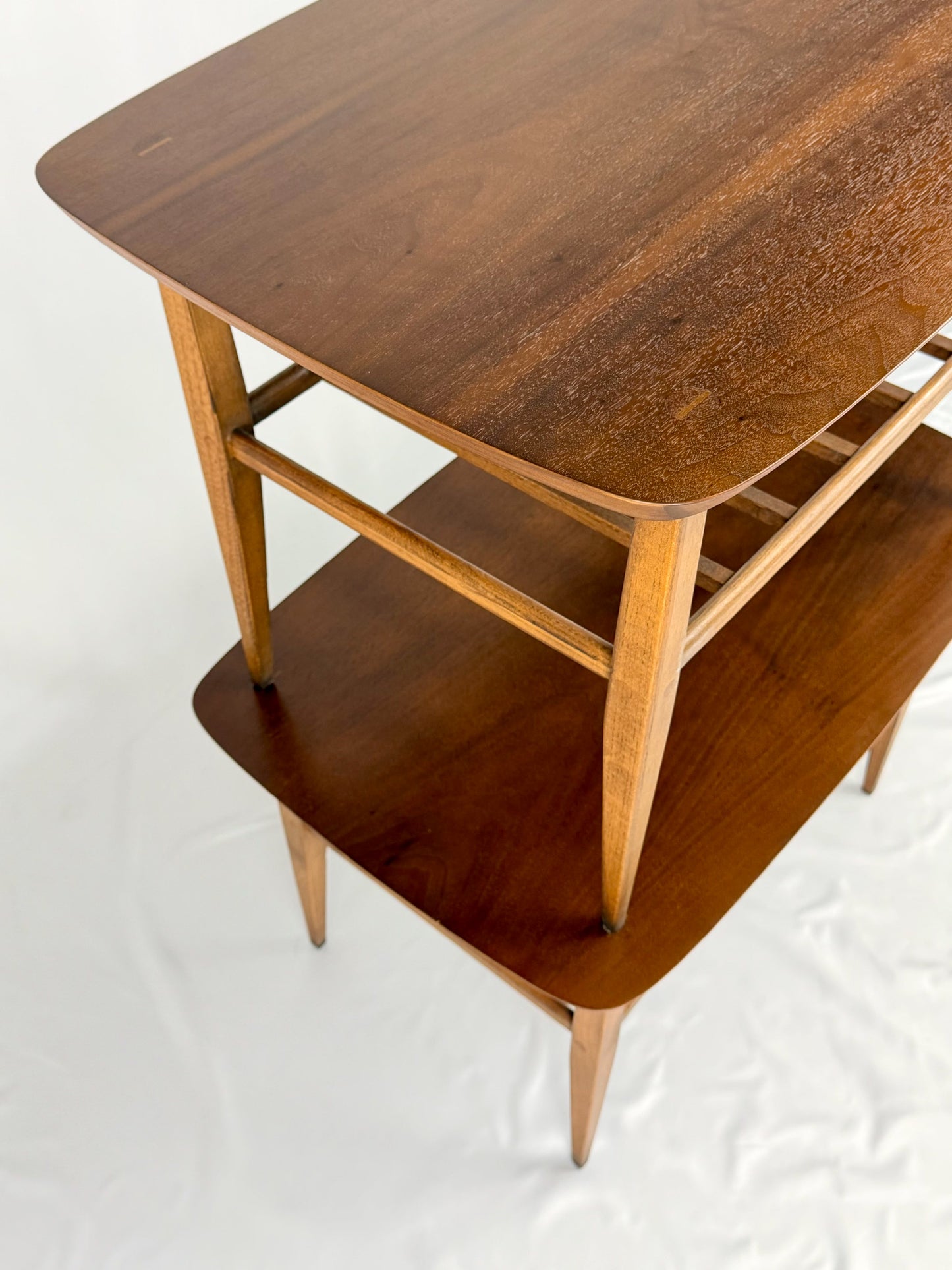 Two wooden side tables on a white background