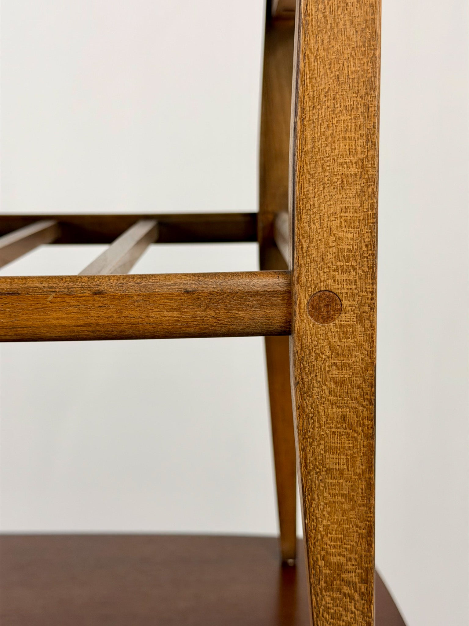 Close-up of a wooden side table with a white background