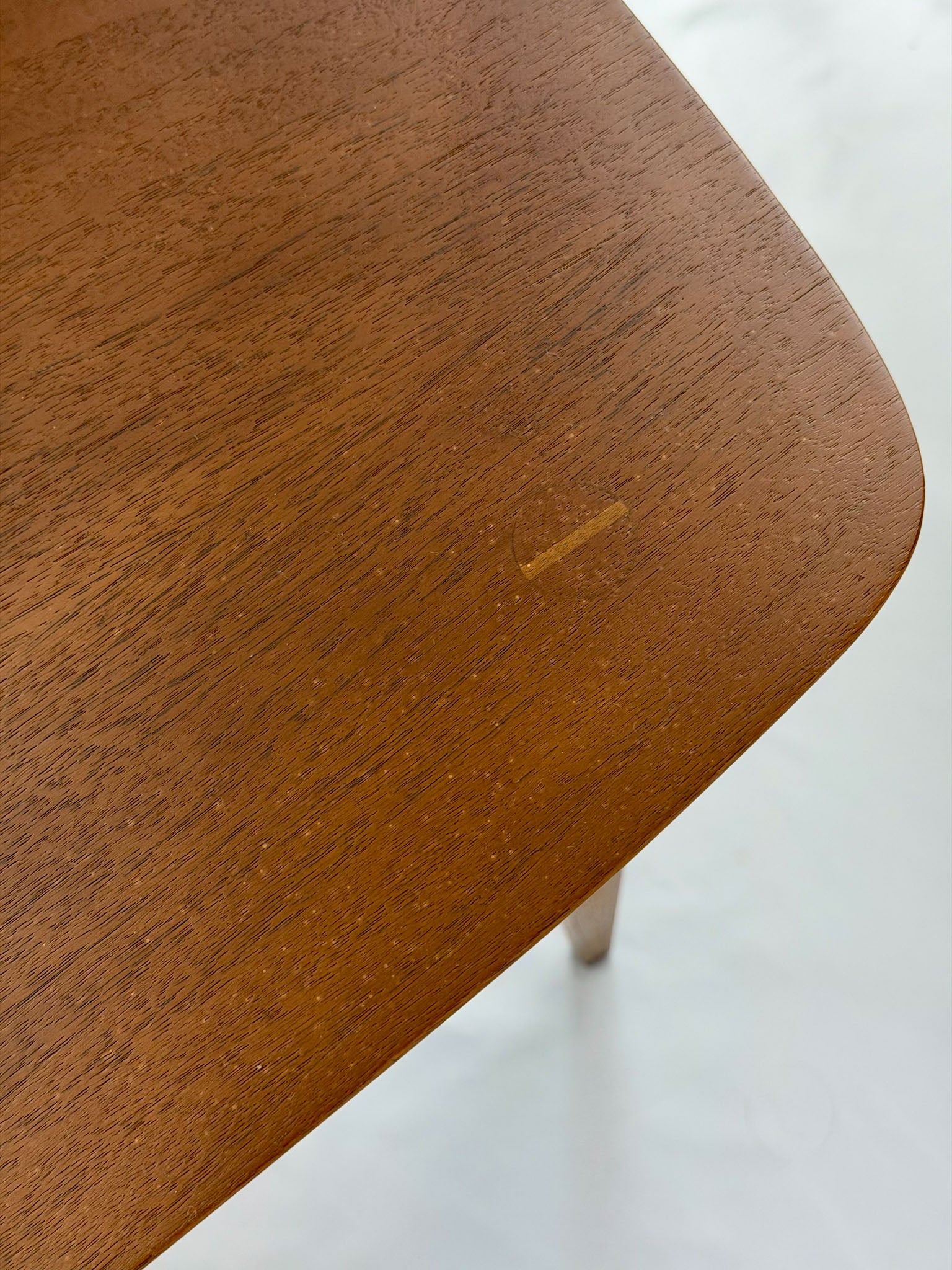 Close-up of a wooden side table with a white background