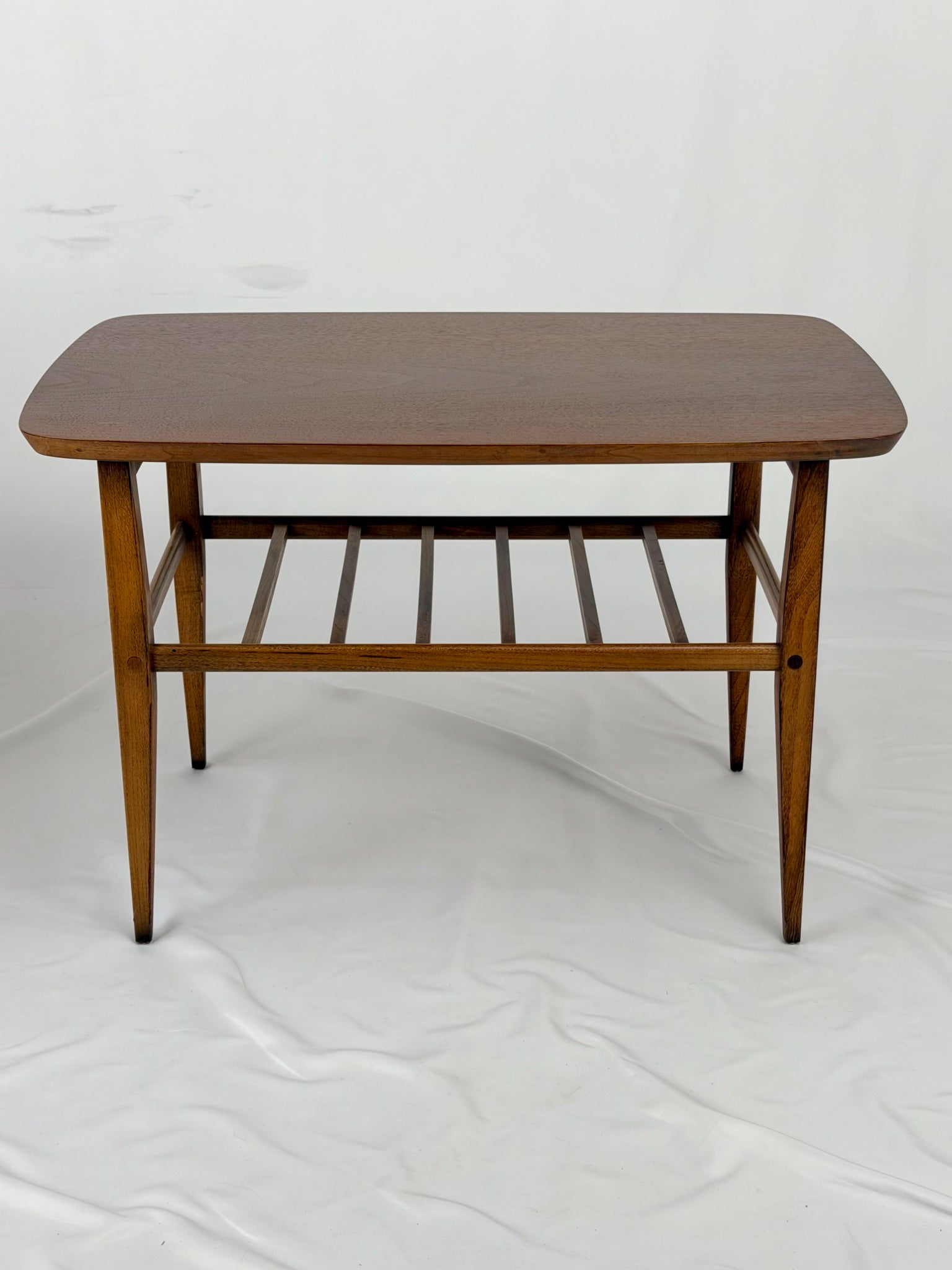 Two wooden side tables on a white background