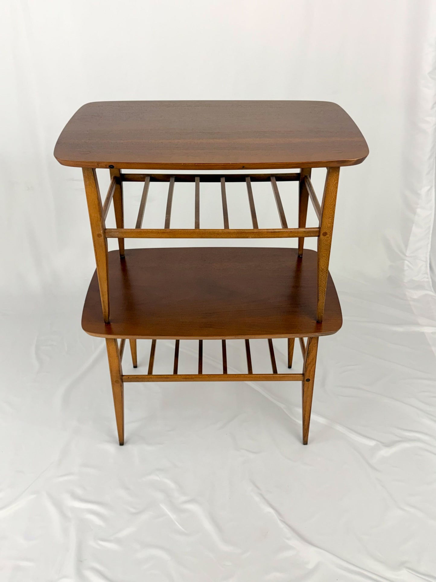 Two wooden side tables on a white background
