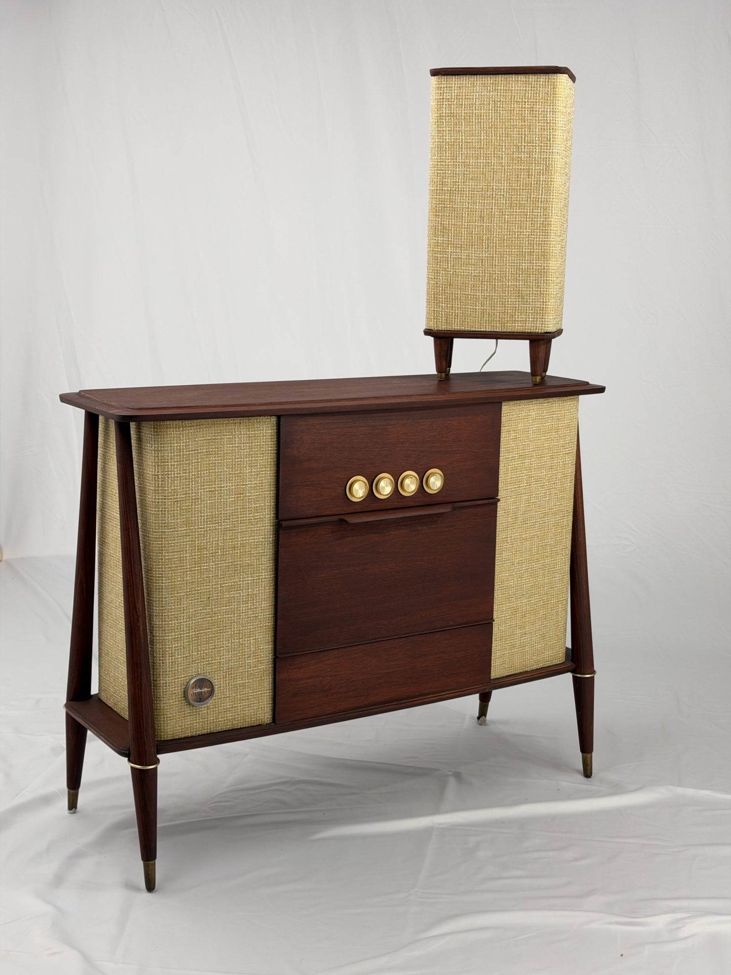 Wooden console with speaker on a white background