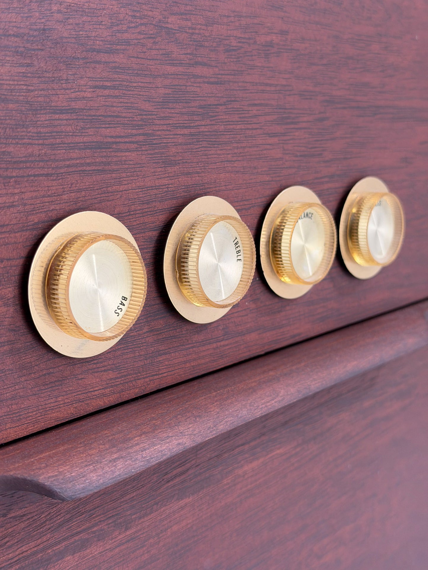 Vintage-style wooden console with beige textured panels on a white background