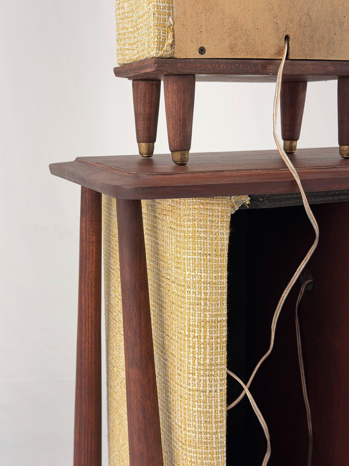 Vintage-style wooden console with beige textured panels on a white background