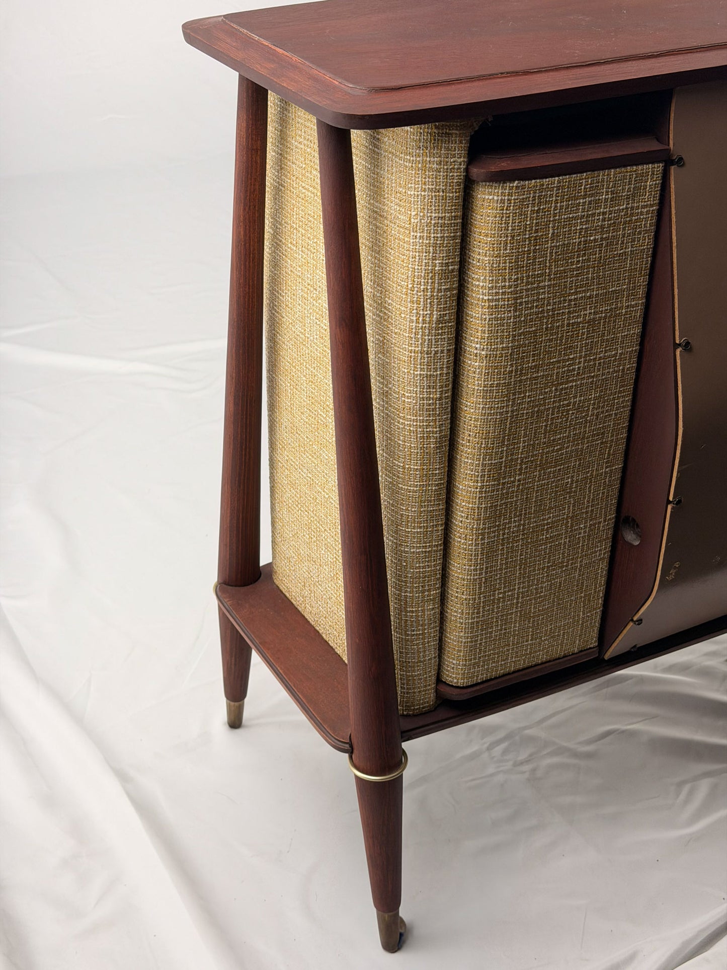 Vintage-style wooden console with beige textured panels on a white background