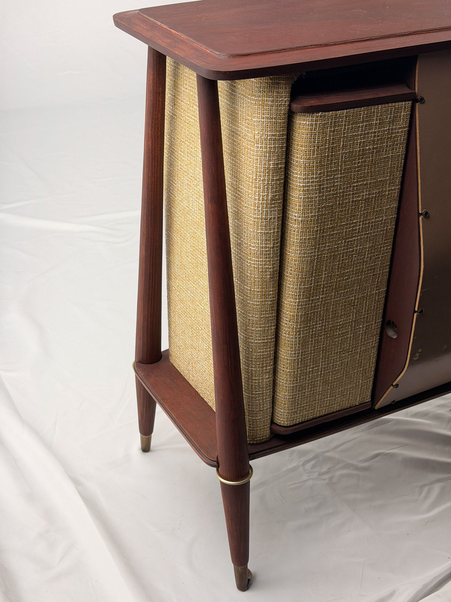 Vintage-style wooden console with beige textured panels on a white background