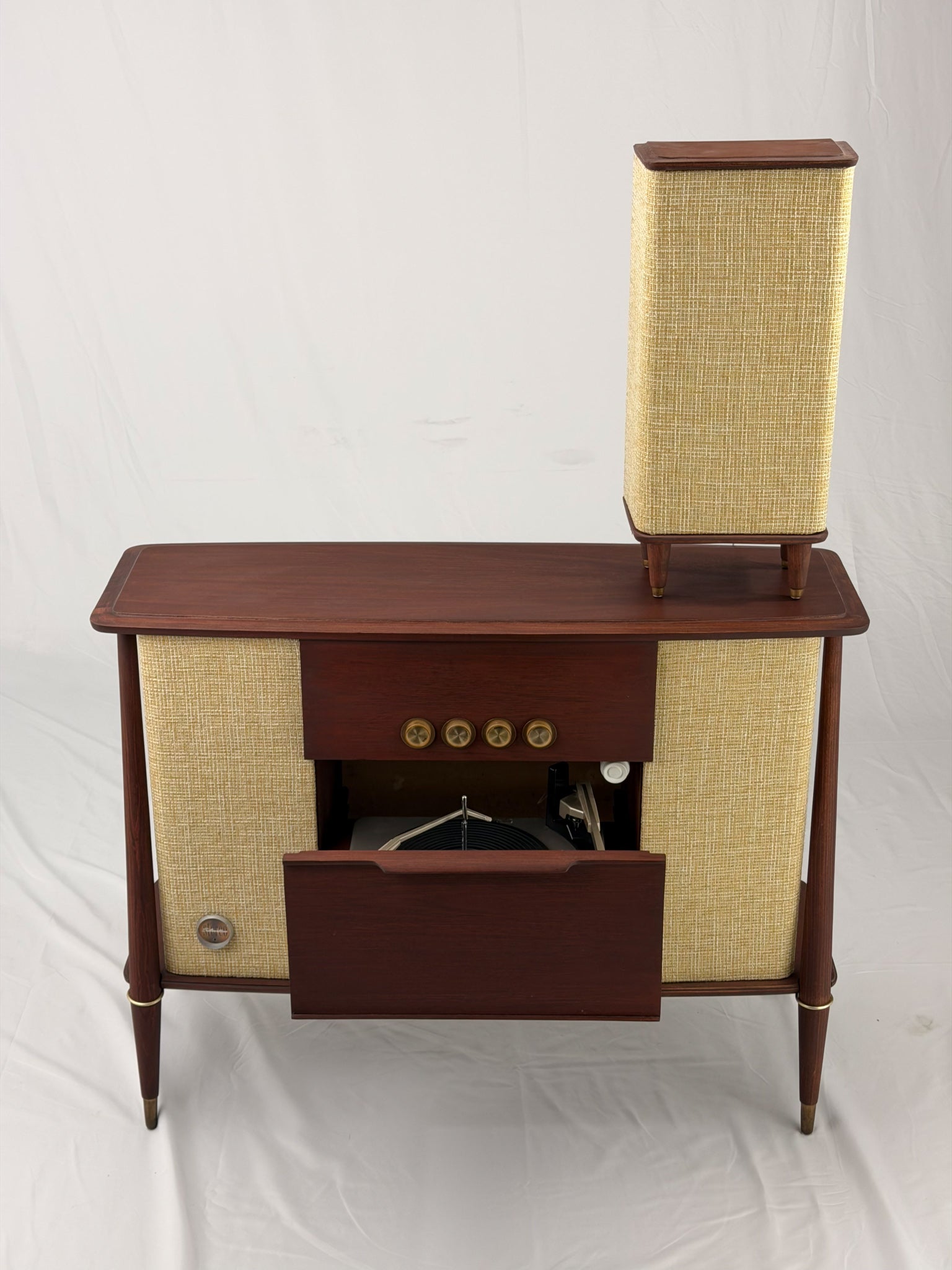 Vintage-style wooden console with beige textured panels on a white background