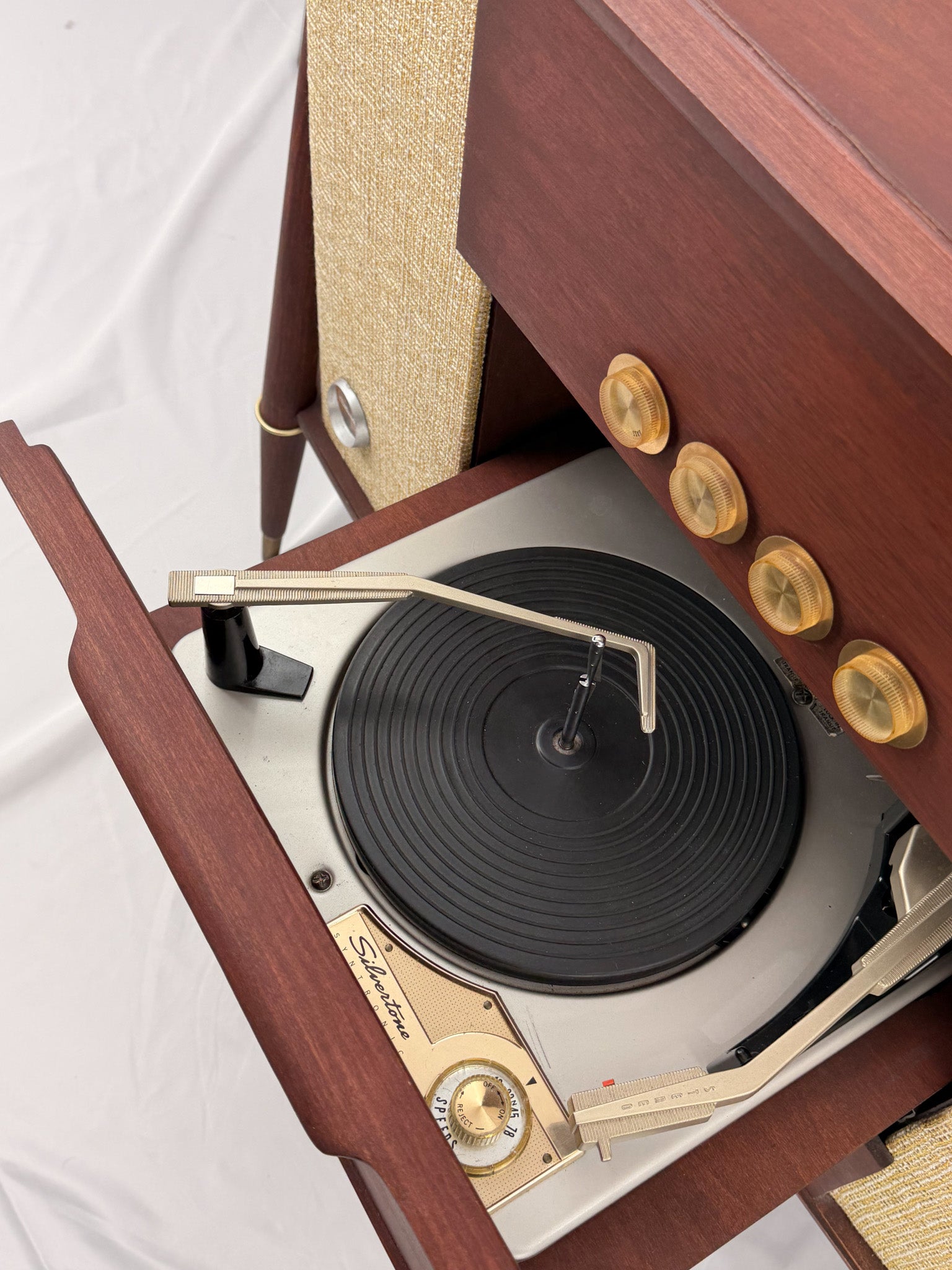 Vintage-style wooden console with beige textured panels on a white background