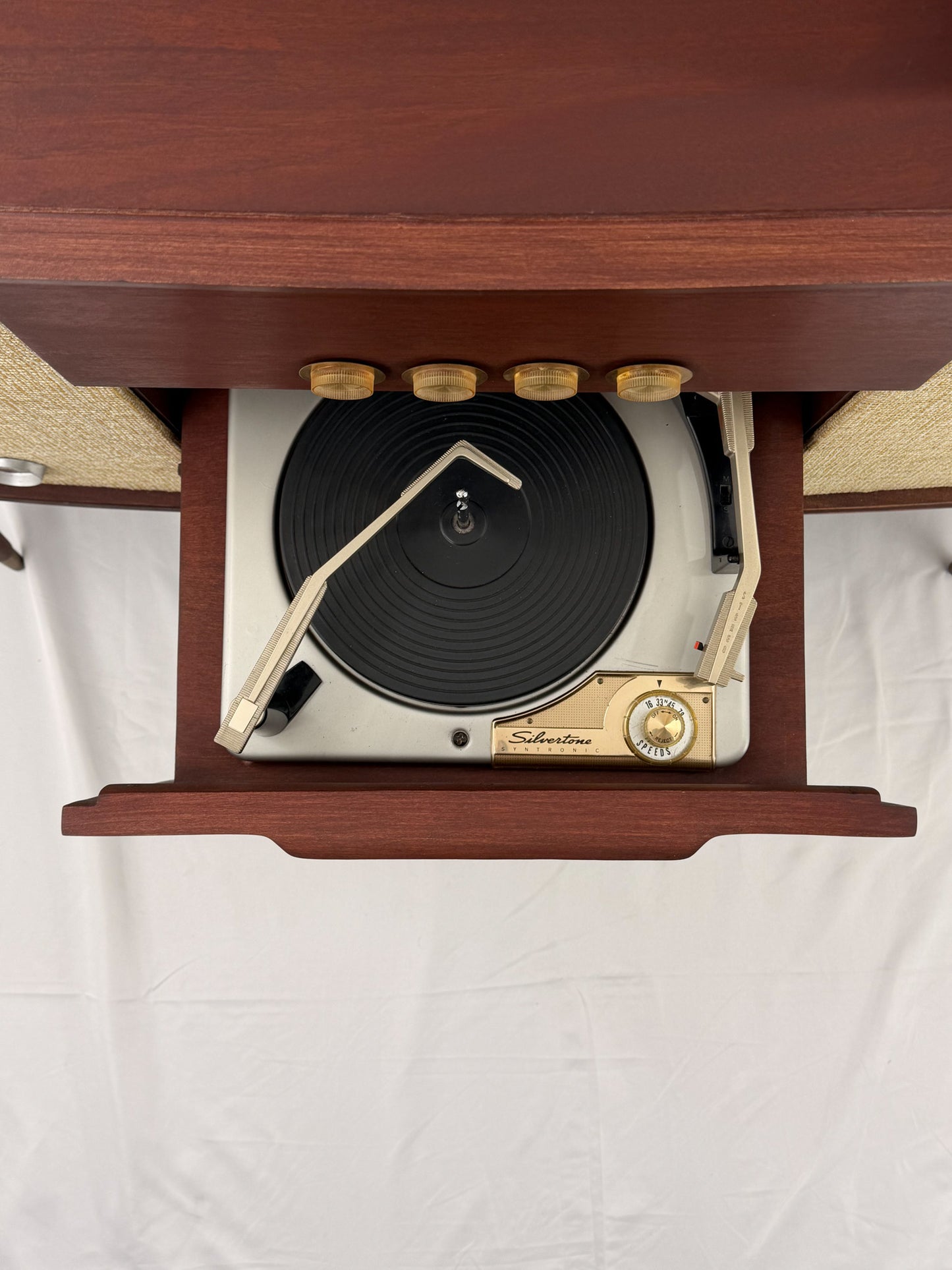 Vintage-style wooden console with beige textured panels on a white background