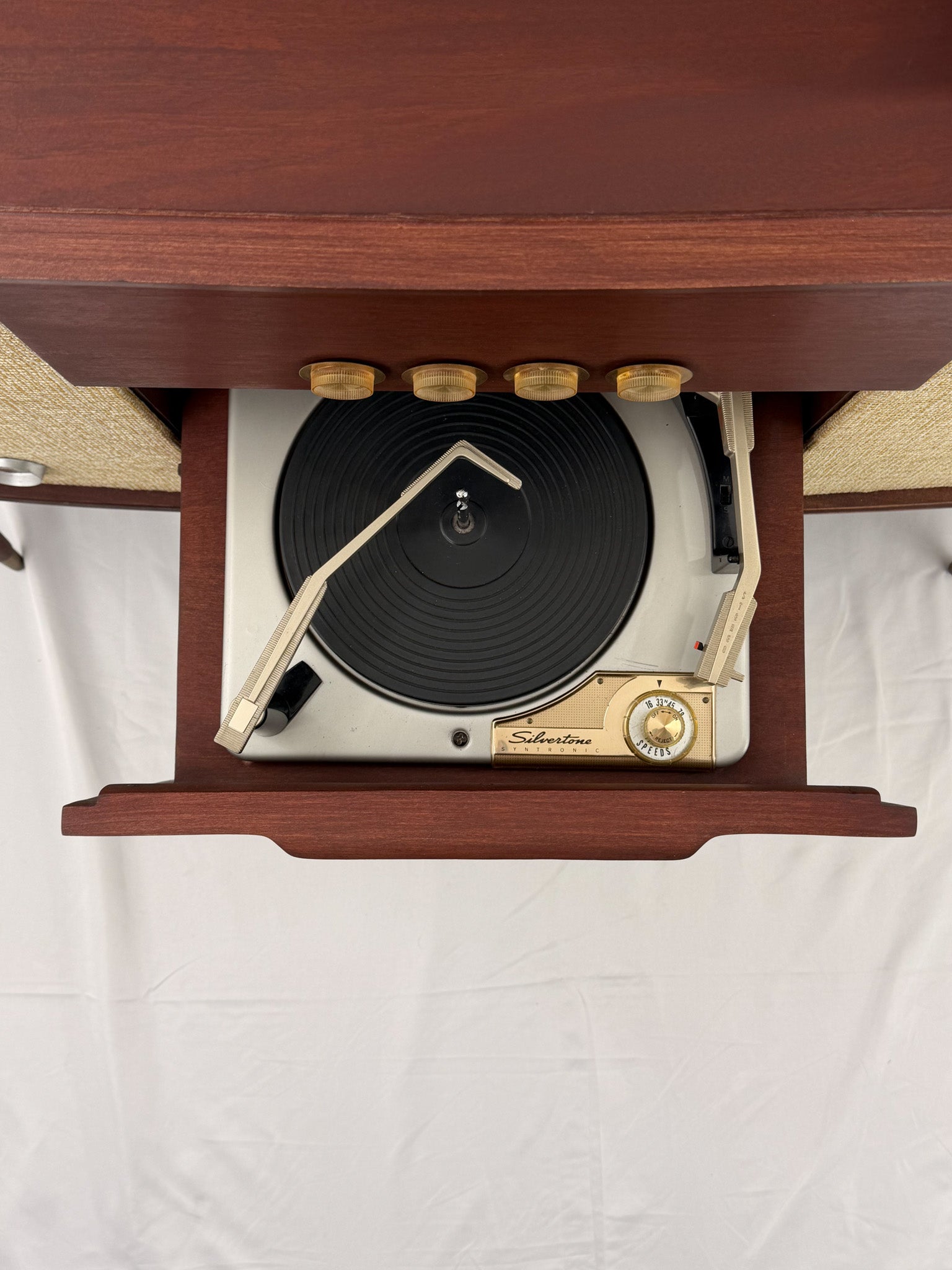 Vintage-style wooden console with beige textured panels on a white background