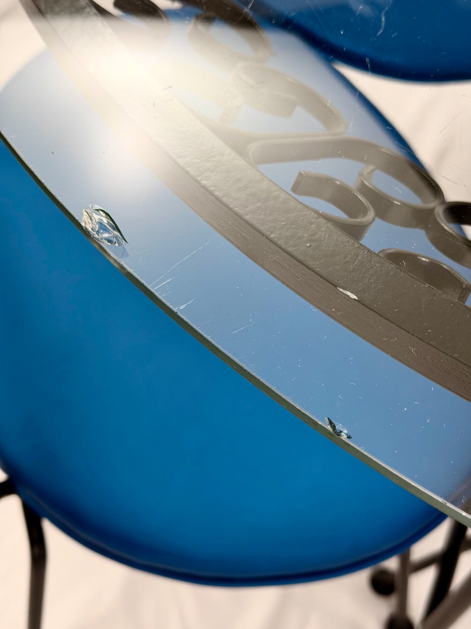 Close-up of a blue chair with a reflective surface
