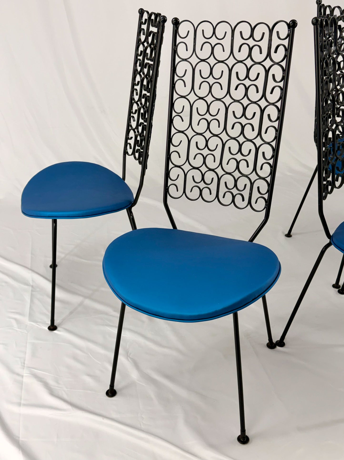 Blue chairs with black metal frames on a white background