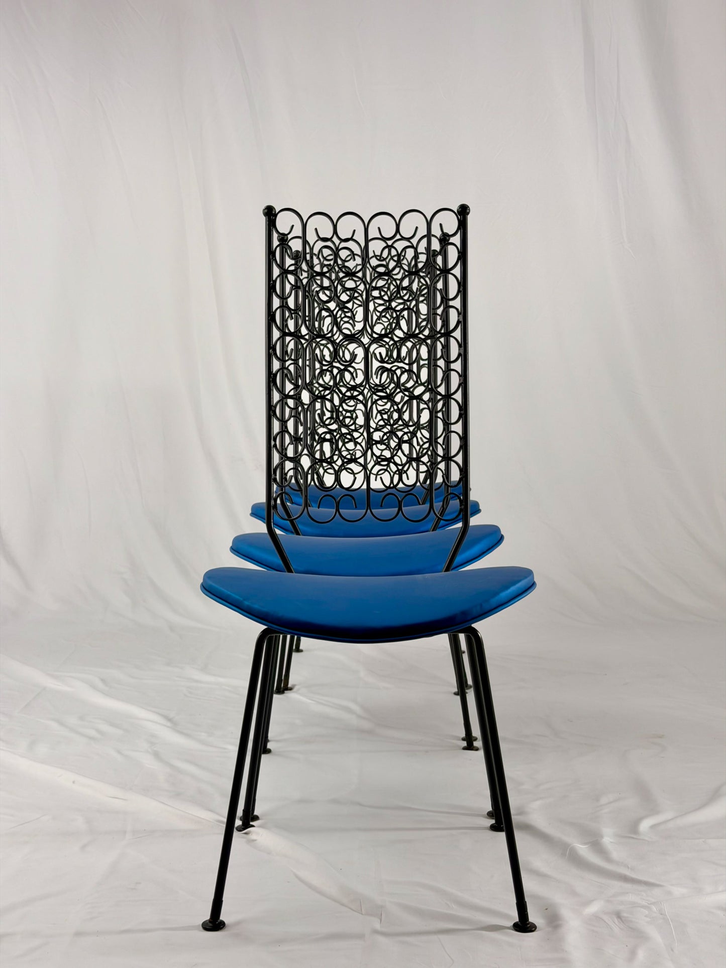 Blue chairs with black metal frames on a white background
