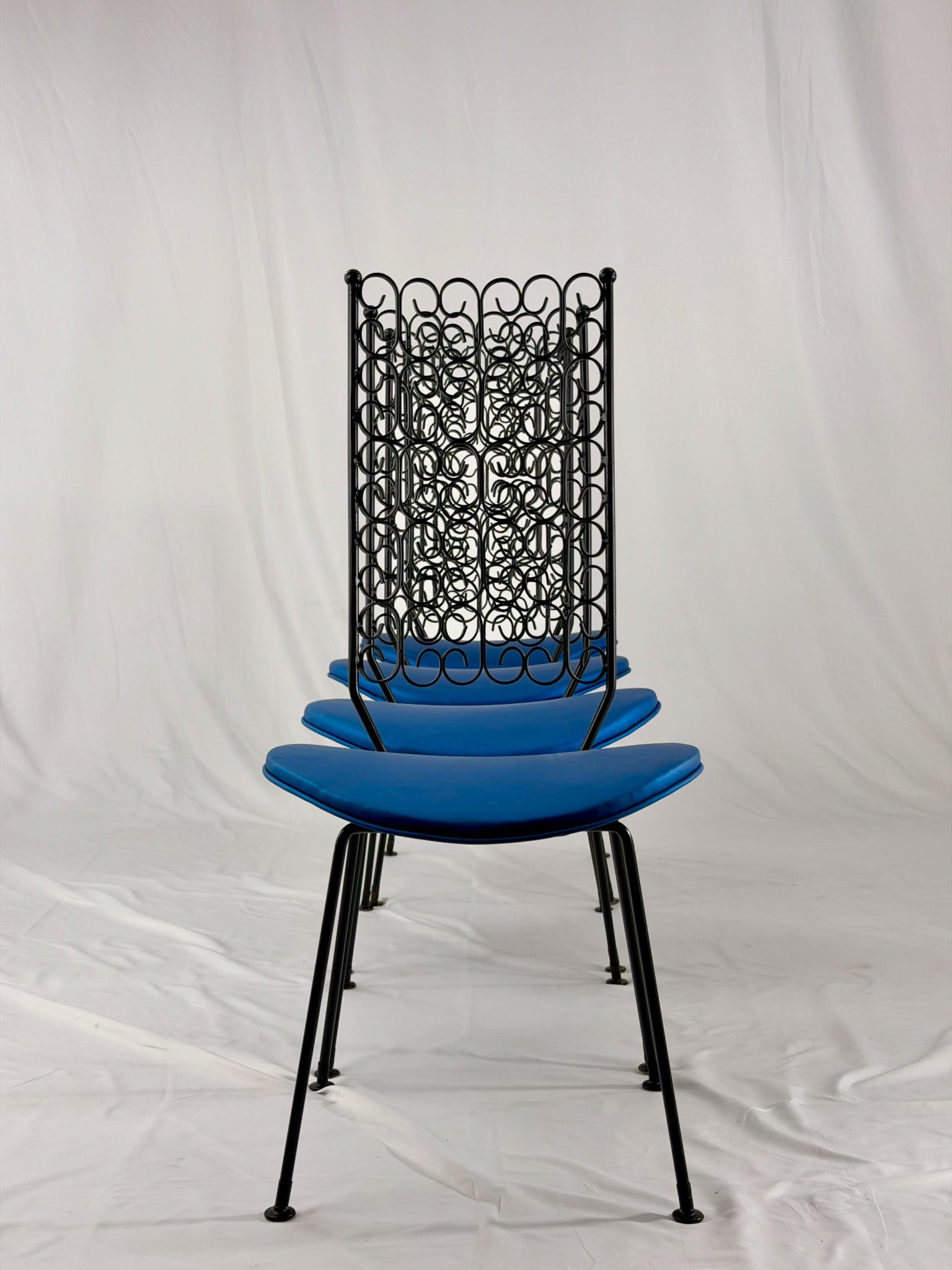 Blue chairs with black metal frames on a white background