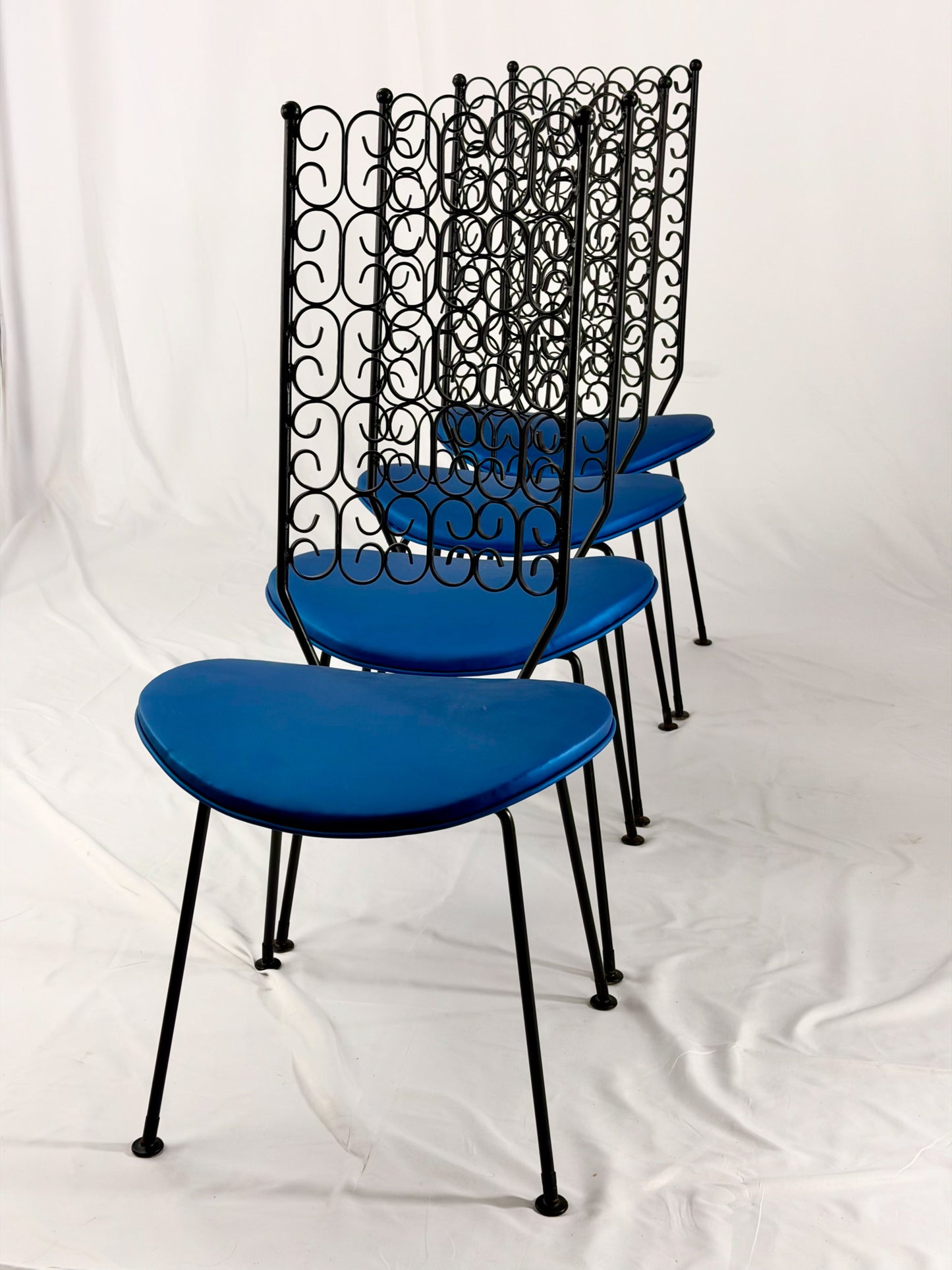 Blue chairs with black metal frames on a white background